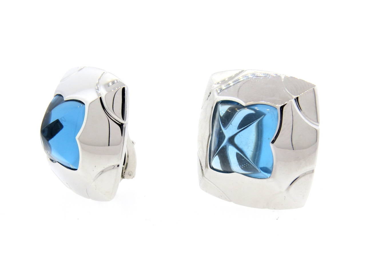 A pair of 18k white gold earrings set with blue topaz from the Piramide collection by Bulgari.  The earrings measure 25mm x 25mm and weigh 34.1 grams.