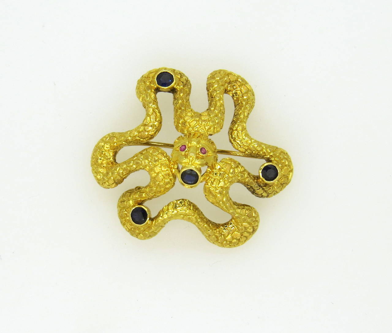 Ilias Lalaounis Greece 18k gold serpent snake brooch, decorated with four sapphires and two ruby eyes. Brooch is 45mm x 40mm. Marked Greece, K18,Ilias Lalaounis. weight of the piece - 24.2 gr