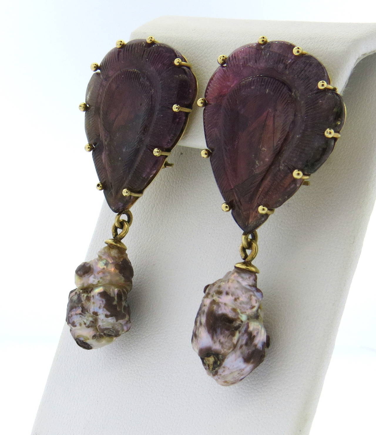 Stephen Dweck 18k gold earrings with hand carved pink tourmalines and natural strawberry pearl drops. Earrings measure 58mm x 28mm. Marked Stephen Dweck  and 18k. Come in original box. Weight - 30.9 grams