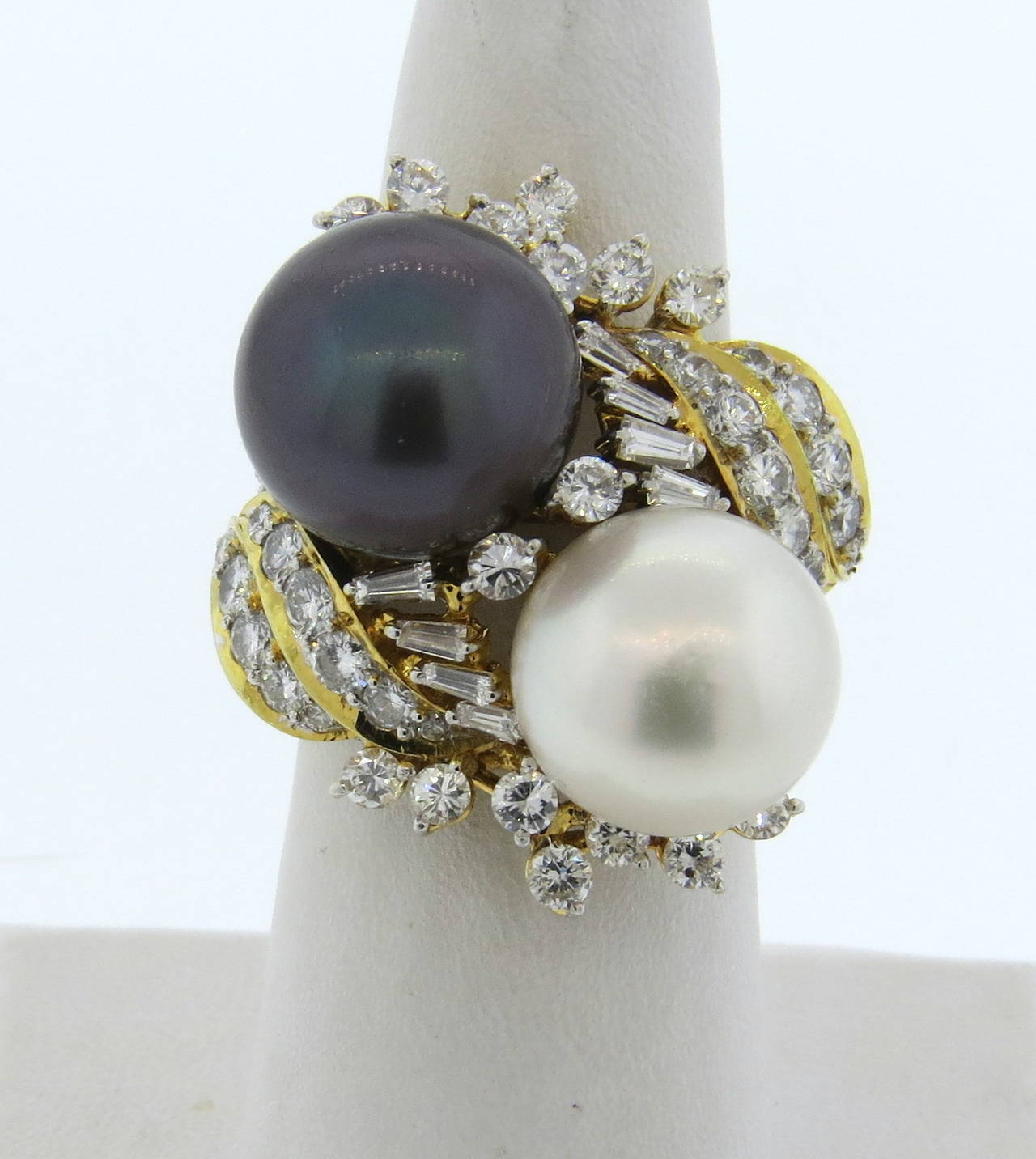Gucci 18k gold cocktail ring with two South Sea pearls, measuring 12.6mm and 13.3mm in diameter, surrounded with approx. 2.20 ctw diamonds. Ring size 6 1/2, ring top is 31mm x 27mm, ring sits approx. 21mm from the finger. Marked Gucci,750,18k.