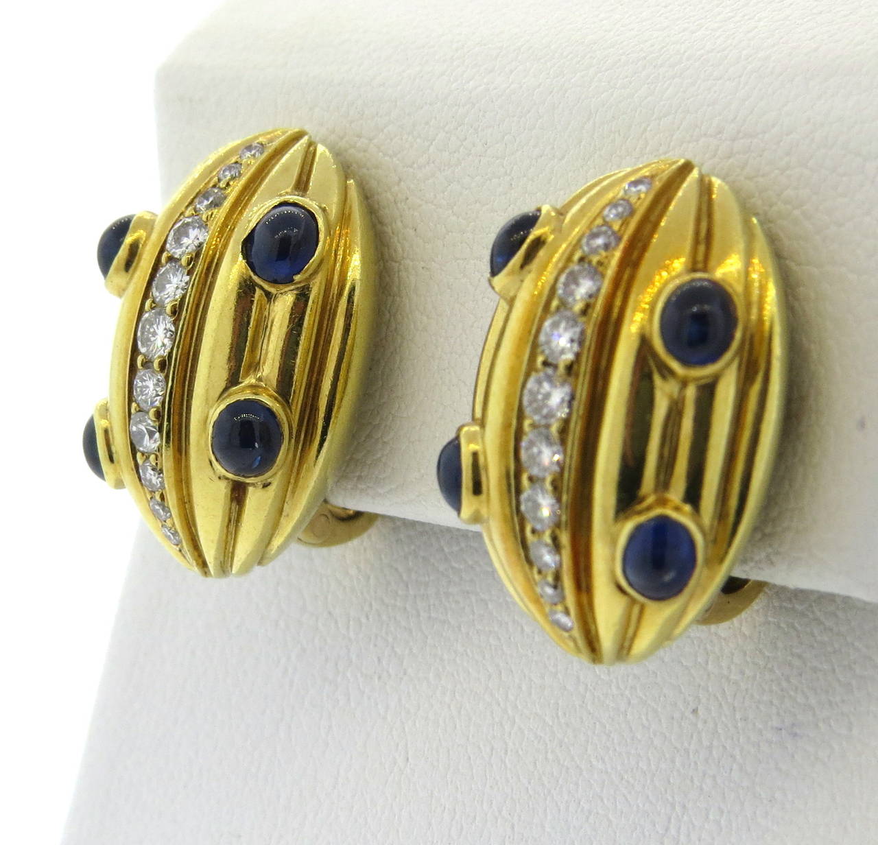 18k gold earrings with approx. 0.70ctw VS/G diamonds and sapphire cabochons. Earrings measure 21mm x 16mm. Weight - 19.6 grams