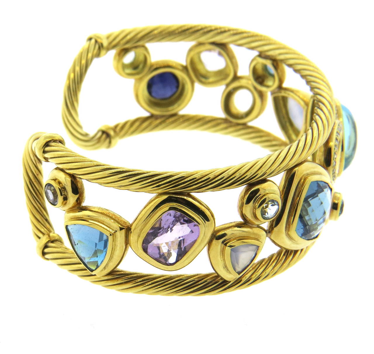 An 18k yellow gold bracelet by David Yurman.  The bracelet is set with Diamonds, Iolites, Amethysts, Chalcedony, Blue Topaz and London Blue Topaz.  The bracelet comfortably fits up to a 7