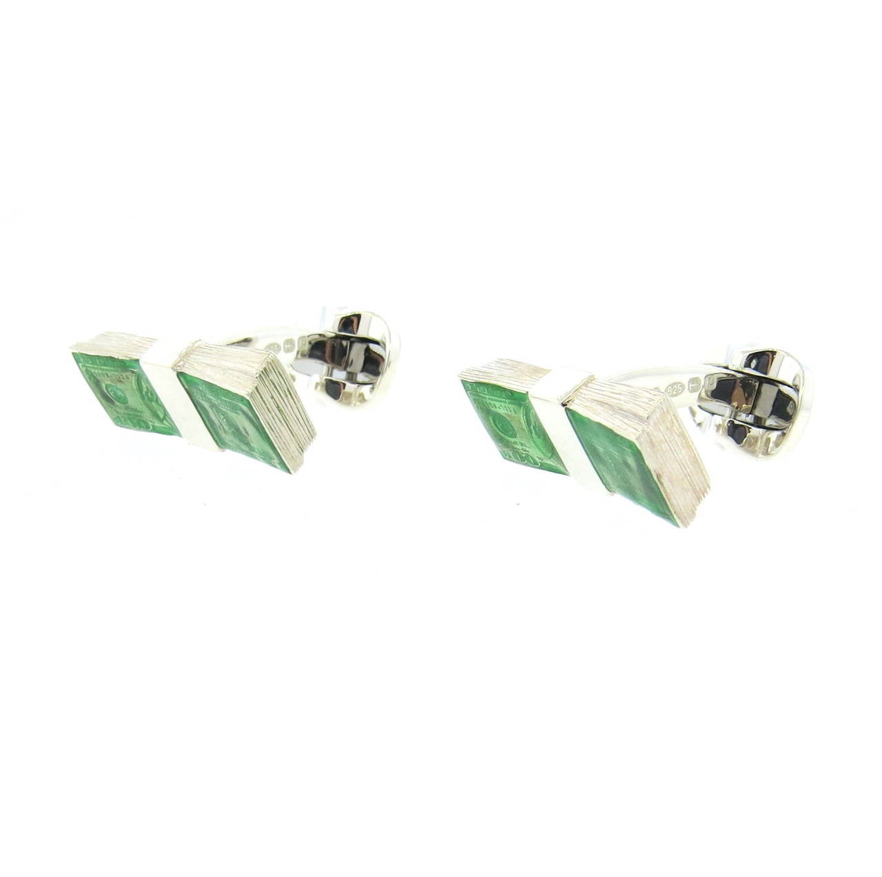 A pair of sterling silver and enamel cufflinks depicting hundred dollar bills.  Crafted by Deakin & Francis, the cufflinks measure 24mm x 10mm and weigh 17.6 grams.