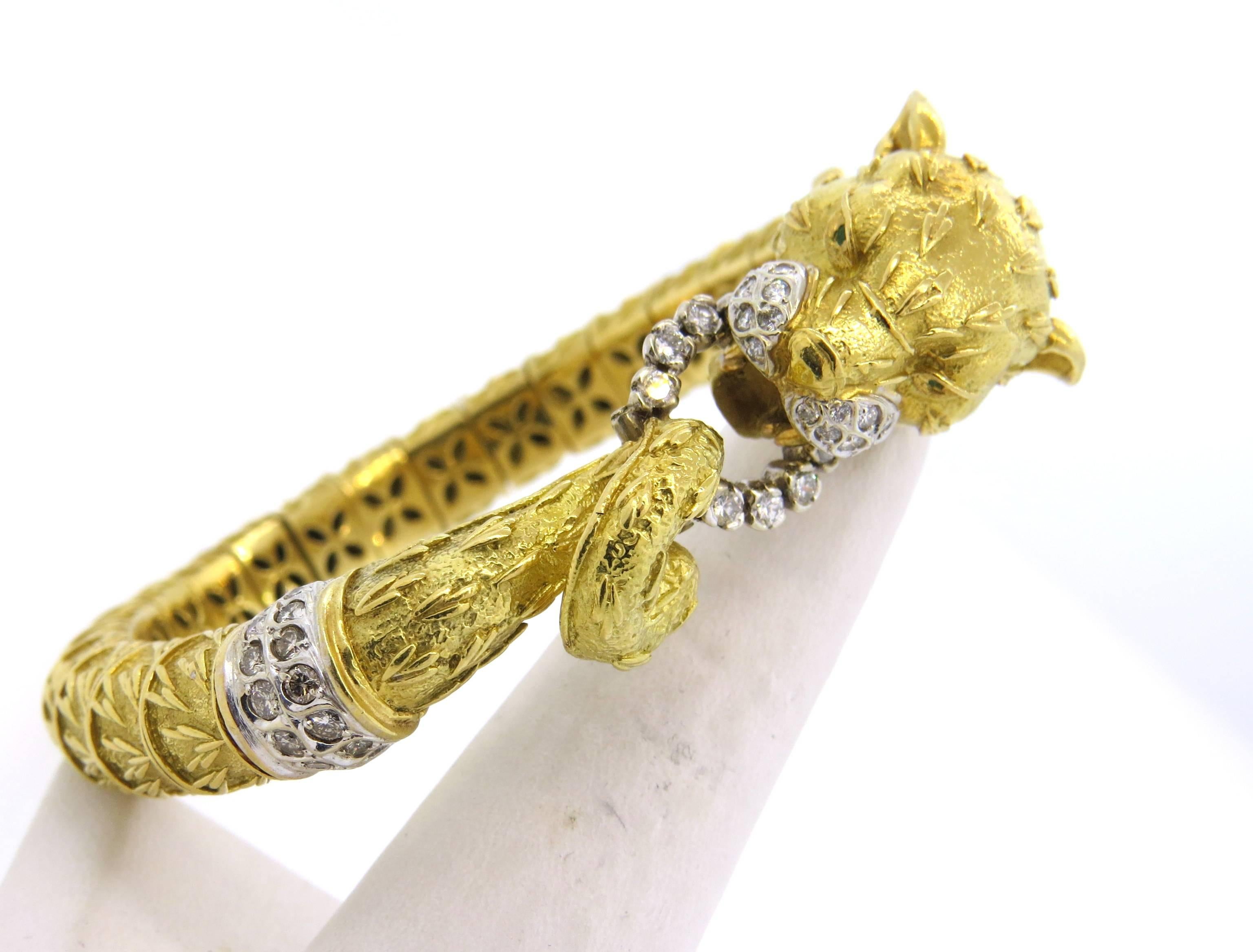 Large 18k yellow gold bangle bracelet, crafted by Frascarolo, featuring panther head, decorated with emerald eyes and approximately 1.08ctw in GH/VS diamonds. Bracelet will comfortably fit up to 7