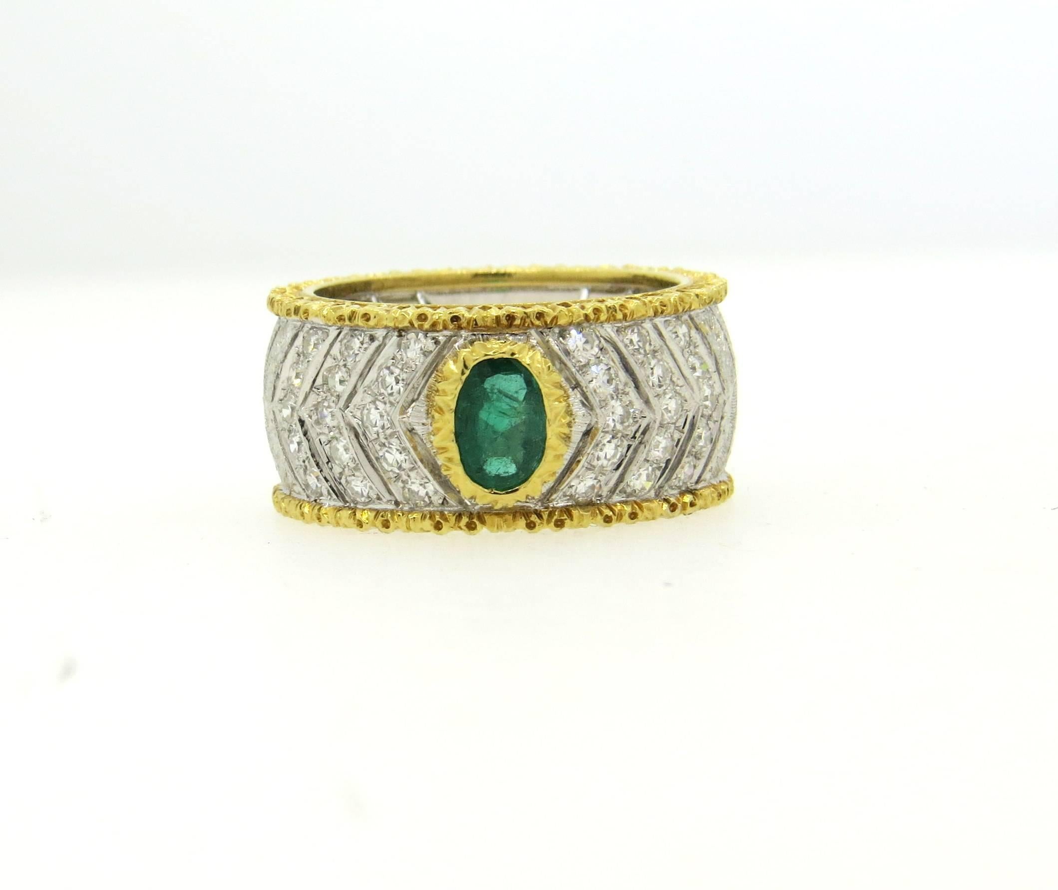 Beautiful 18k white and yellow gold band ring, crafted by Mario Buccellati, decorated with a 0.60ct emerald and approx. 0.35ctw in G/VS diamonds. Ring is a size 6 and is 10mm wide. Marked M. Buccellati. Weight of the piece - 8.9 grams

