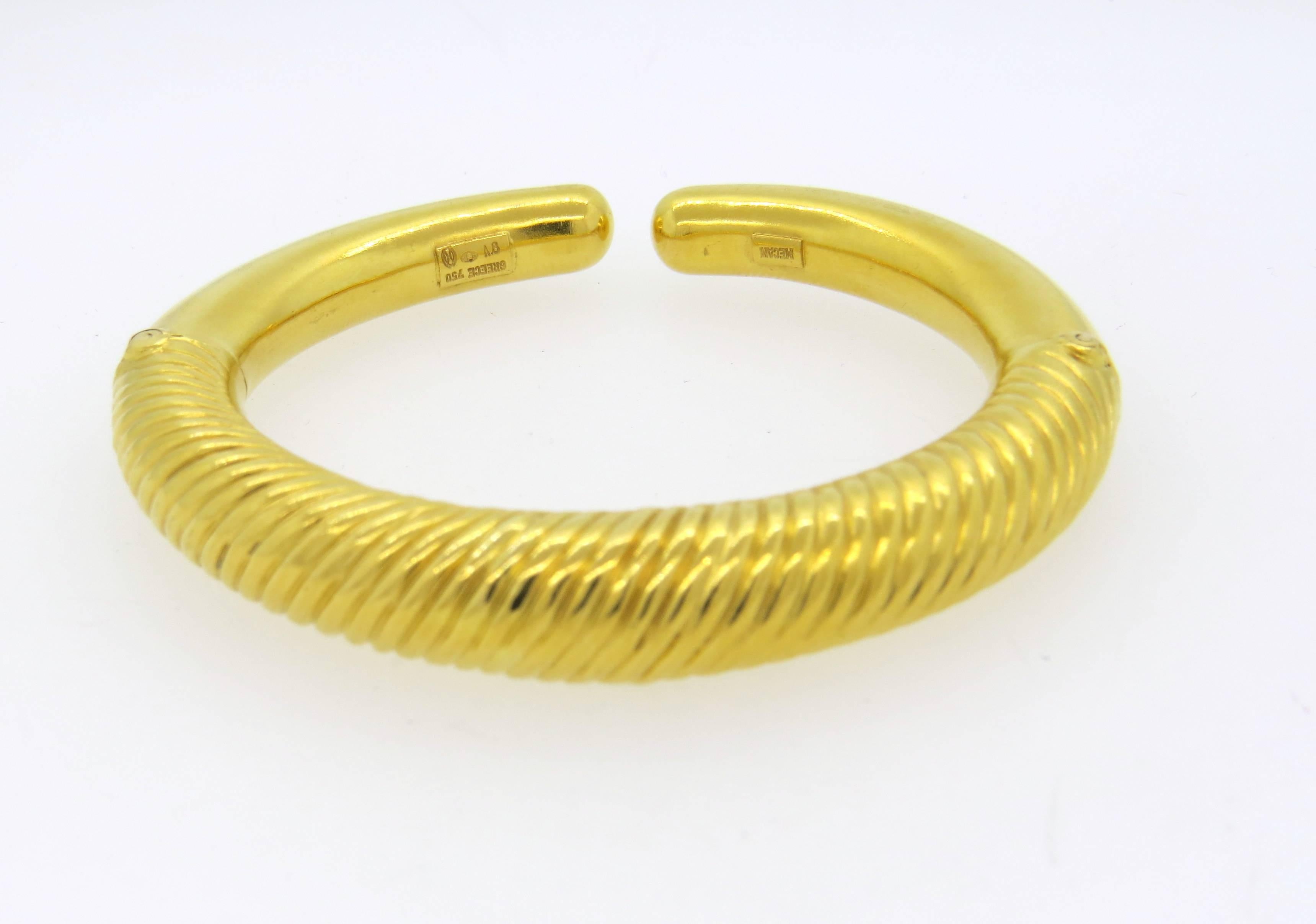18k yellow gold cuff bracelet, crafted by Ilias Lalaounis. Bracelet will comfortably fit up to 7