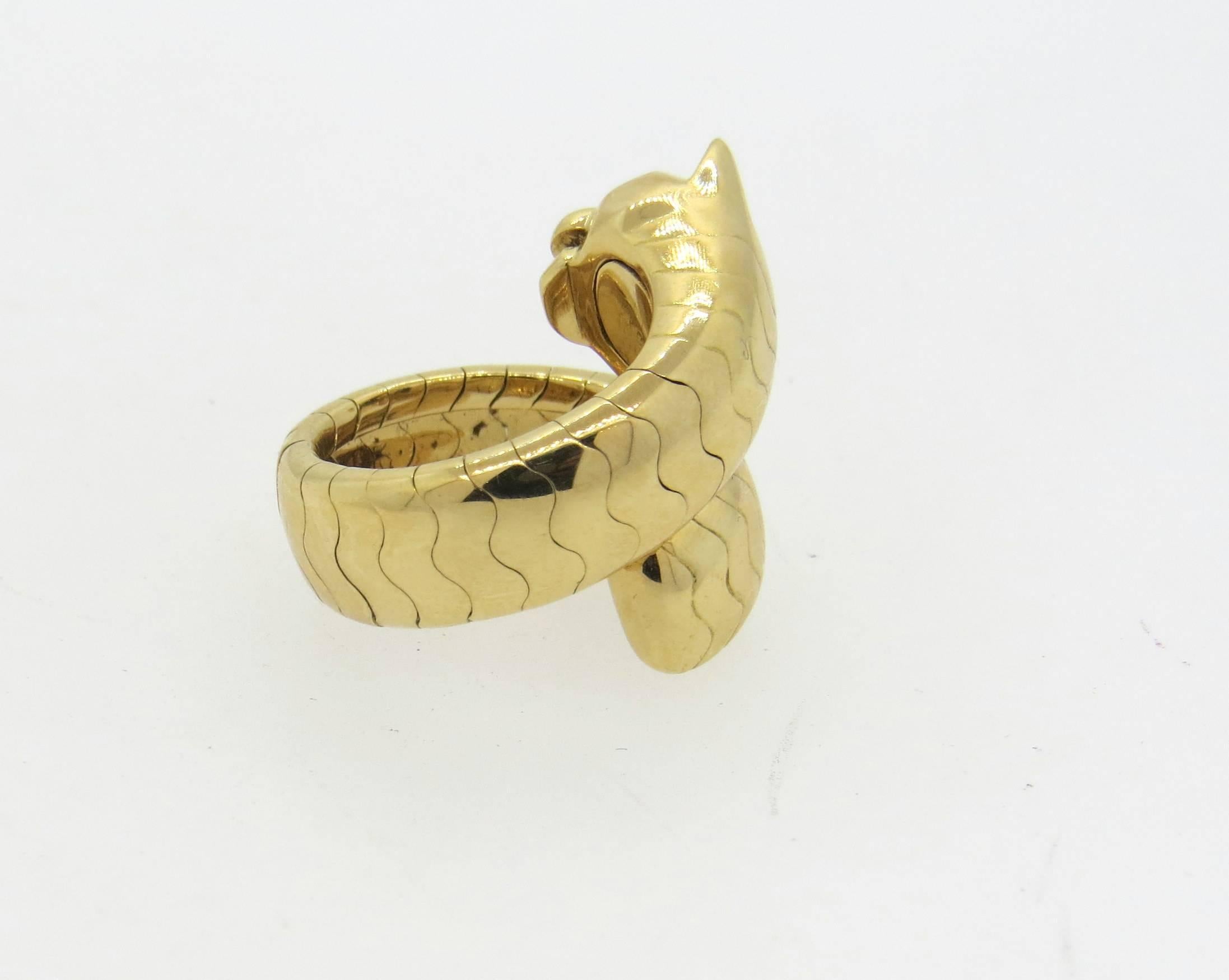 Impressive Cartier 18k yellow gold ring, crafted for Panthere collection, decorated with emerald eyes and onyx nose. Ring is a size 6 (slightly flexible), ring top is 21mm at widest point. Marked: 52, French gold marks,728015, Cartier, 750. Weight
