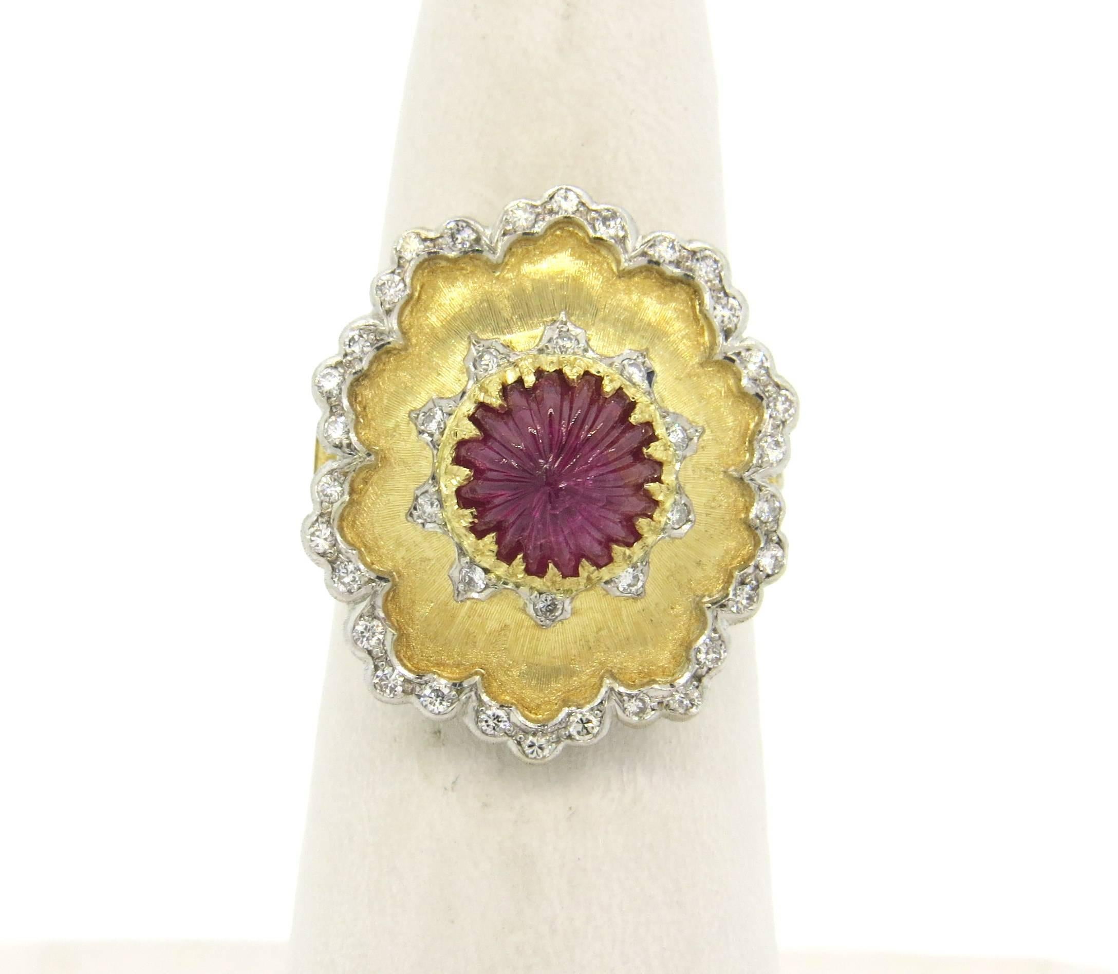 Impressive 18k yellow ans white gold ring, crafted by Buccellati, set with carved ruby in the center, surrounded with diamonds. Ring size 6, ring top 21mm x 19mm  . Marked : Buccellati, Italy 18k . Weight of the piece - 10.7 grams 