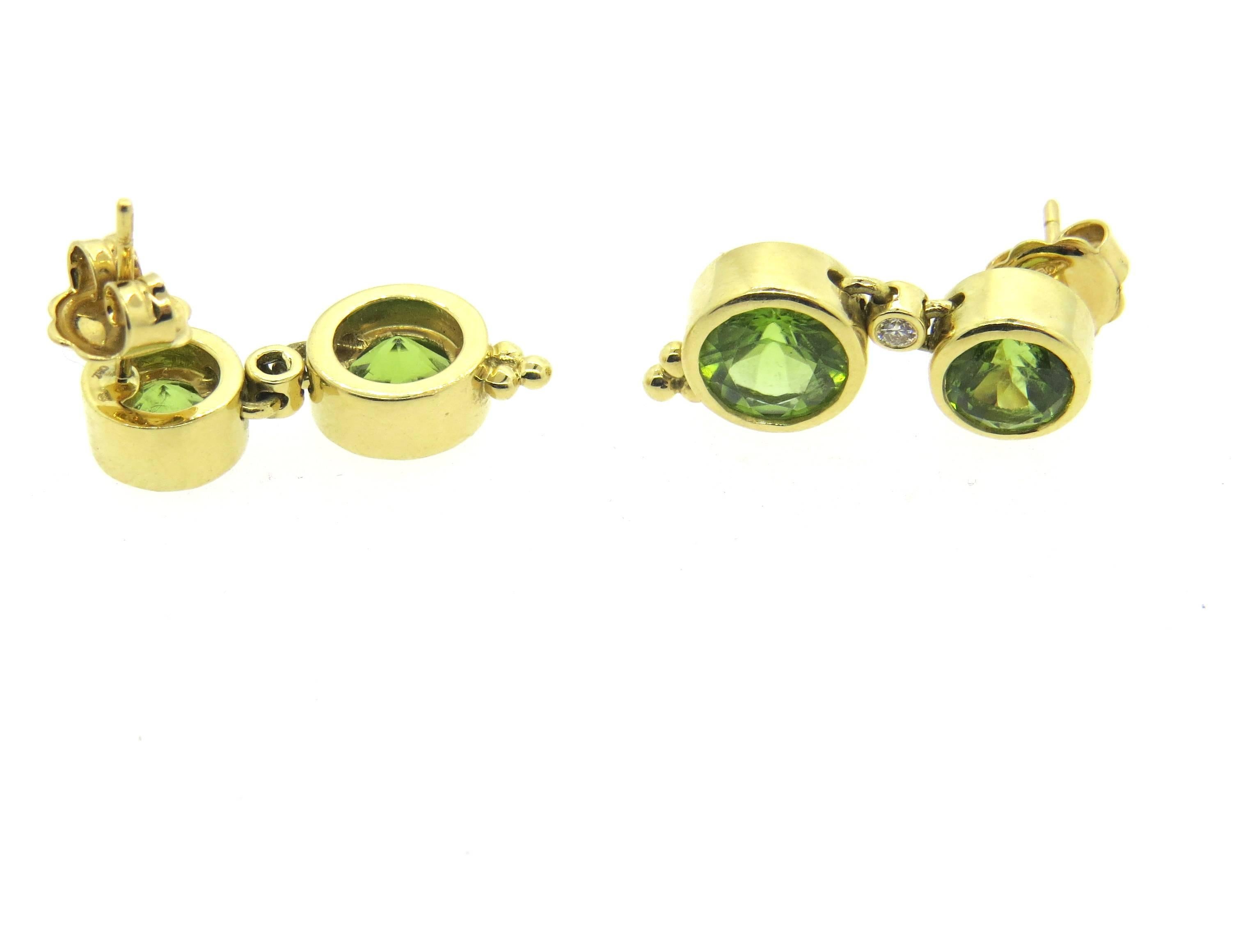 Pair of new 18k yellow gold earrings, crafted by Temple St. Clair , featuring peridot gemstones. and 0.07ctw in G/VS diamonds. Earrings are 24mm x 10mm. Marked with Temple mark and 750. Weight - 9.2 grams
Retail for $3200