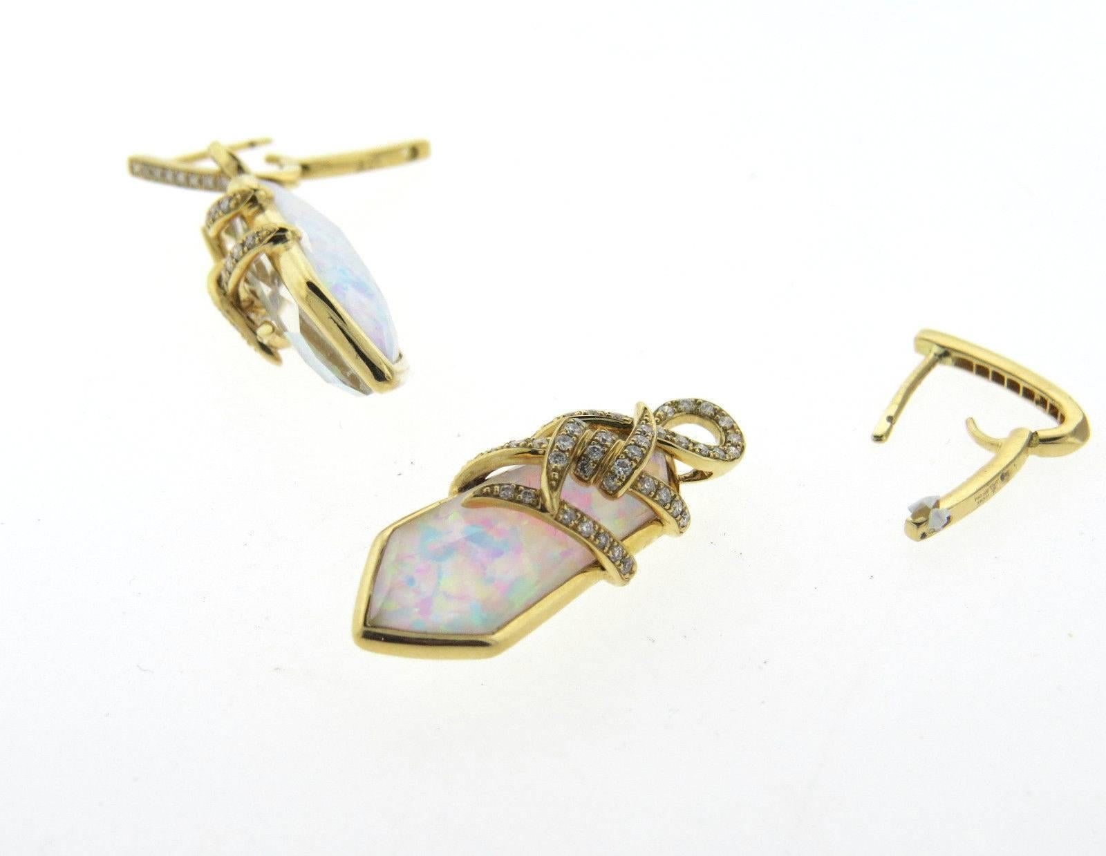 A pair of 18k yellow gold earrings set with approximately 0.65ctw of H/VS diamonds and opal drops.  Crafted by Stephen Webster, the earrings measure 40mm long x 10mm wide (opal drops are removable). Marked 750, Webster mark, SW321.  WEIGHT	10g