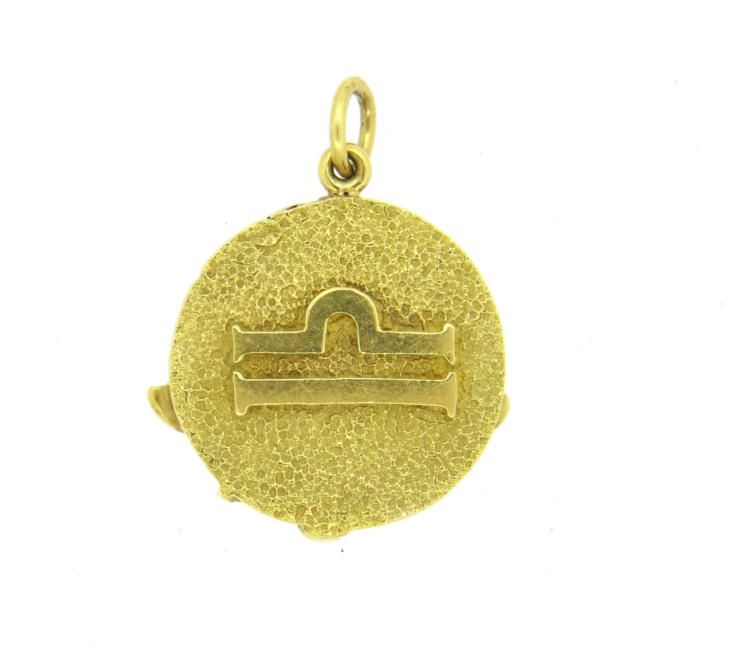 Vintage circa 1970s 18k yellow gold circle pendant, crafted by Tiffany & Co, depicting Libra Zodiac sign. Pendant is 25mm in diameter. Marked : k18 Tiffany, Italy. Weight of the piece - 13 grams