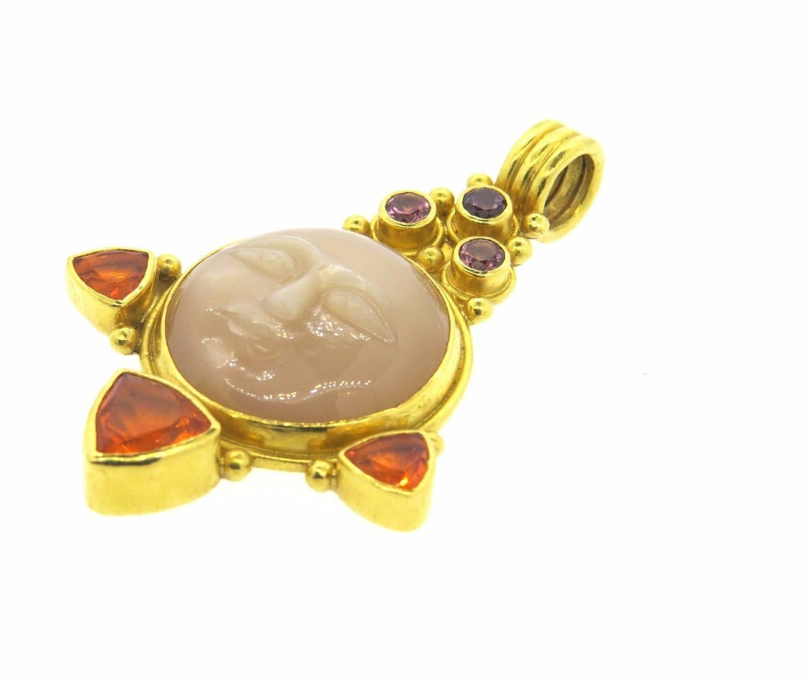 A 22k gold pendant set with multi color gemstones.  Crafted by Gloria Natale, the pendant measures 64mm (including bale) x 42mm.  Marked: Gloria Natale, 1998, 22k.  Weight 32.1 grams.