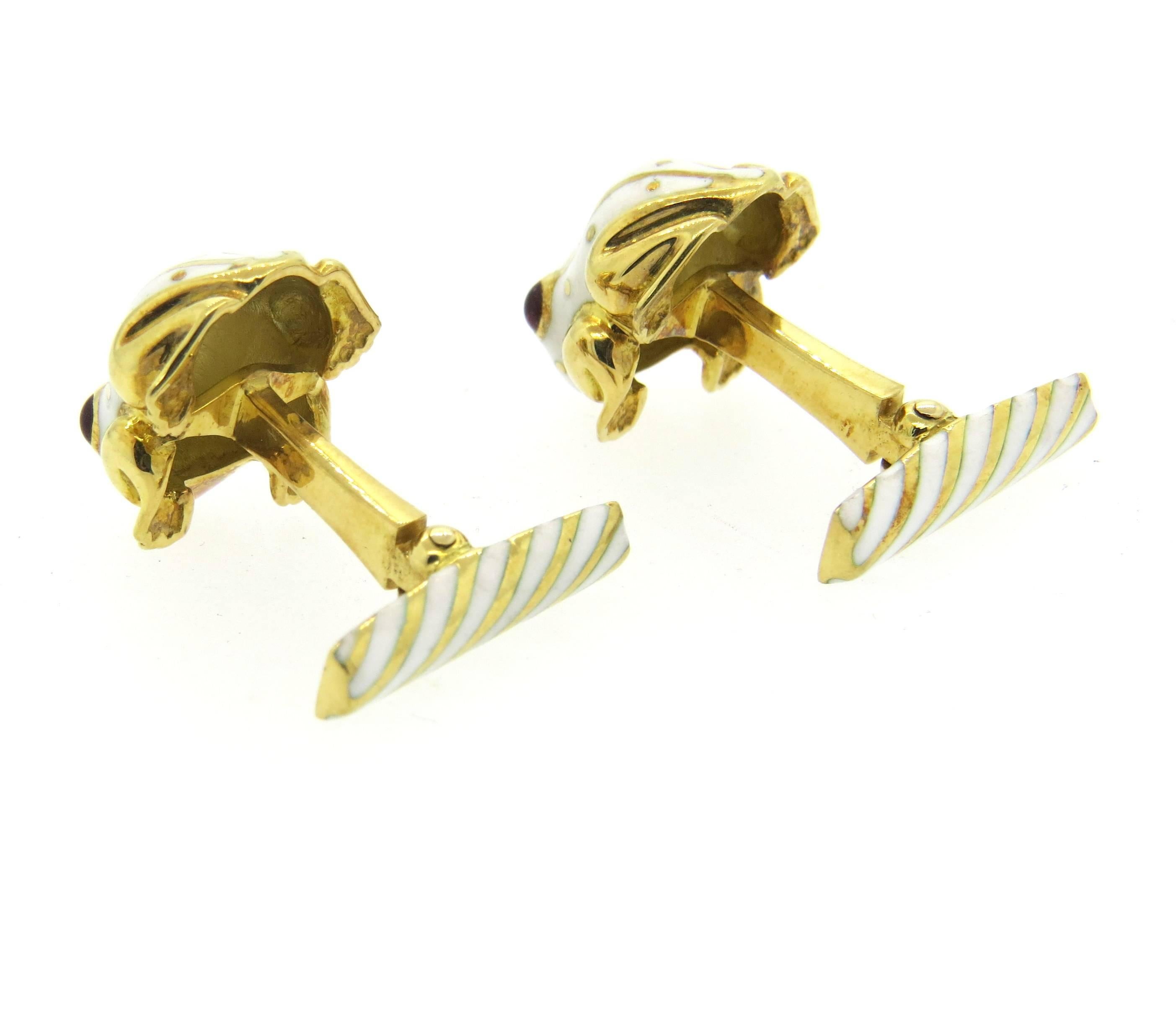 Pair of iconic 18k yellow gold cufflinks, crafted by David Webb, decorated with white enamel and ruby cabochon eyes, depicting frogs. Cufflink top measures 18mm x 14mm. Marked Webb 18k. Weight - 17.6 grams 