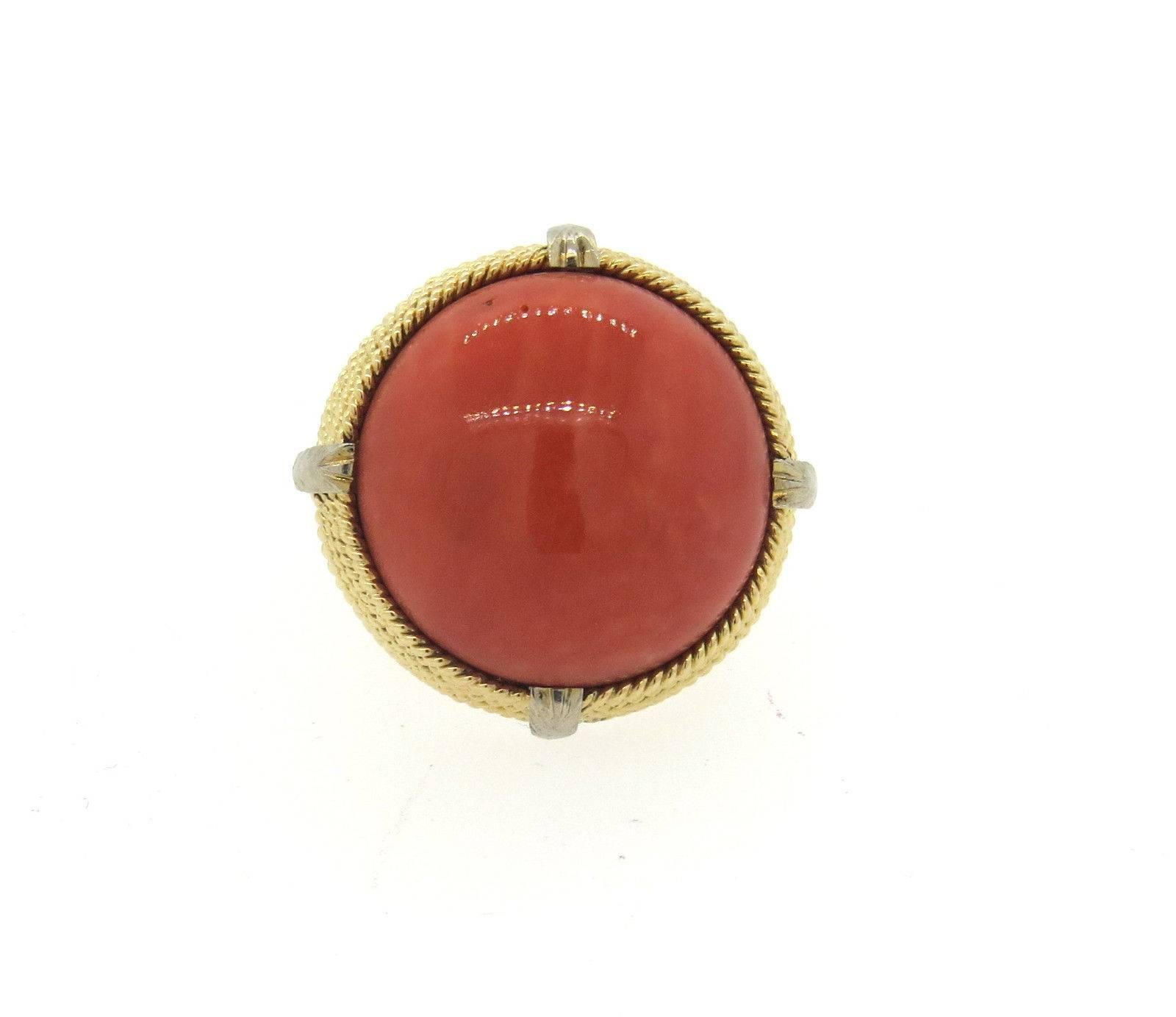 A 14k yellow gold ring set with a 20mm coral cabochon.  The ring is a size 5 and the top of the ring is 25mm in diameter.  The weight of the reing is 17.5 grams.  Marked 14k.