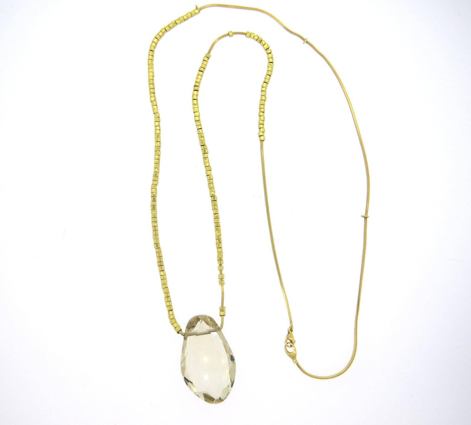 An 18k yellow gold necklace with a topaz pendant measuring 42mm x 26mm x 11.6mm.  Crafted by H. Stern, the necklace is 32