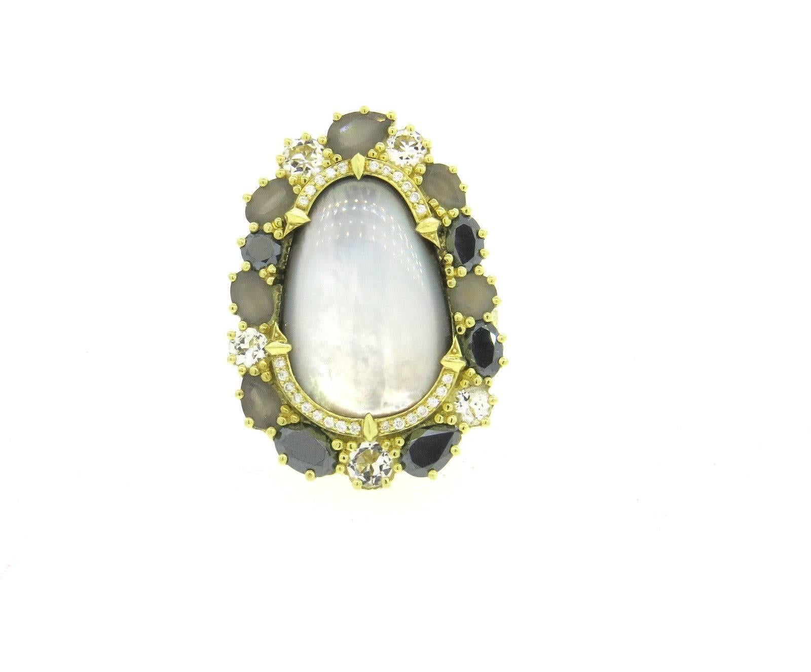 An 18k yellow gold ring set with approximately 0.15ctw of G/VS diamonds, mother of pearl, black diamonds, grey moonstone and a quartz doublet.  Crafted by Judith Ripka, the ring is a size 7 1/4, ring top is 33mm x 23mm.  Marked: Judith Ripka, 18k. 