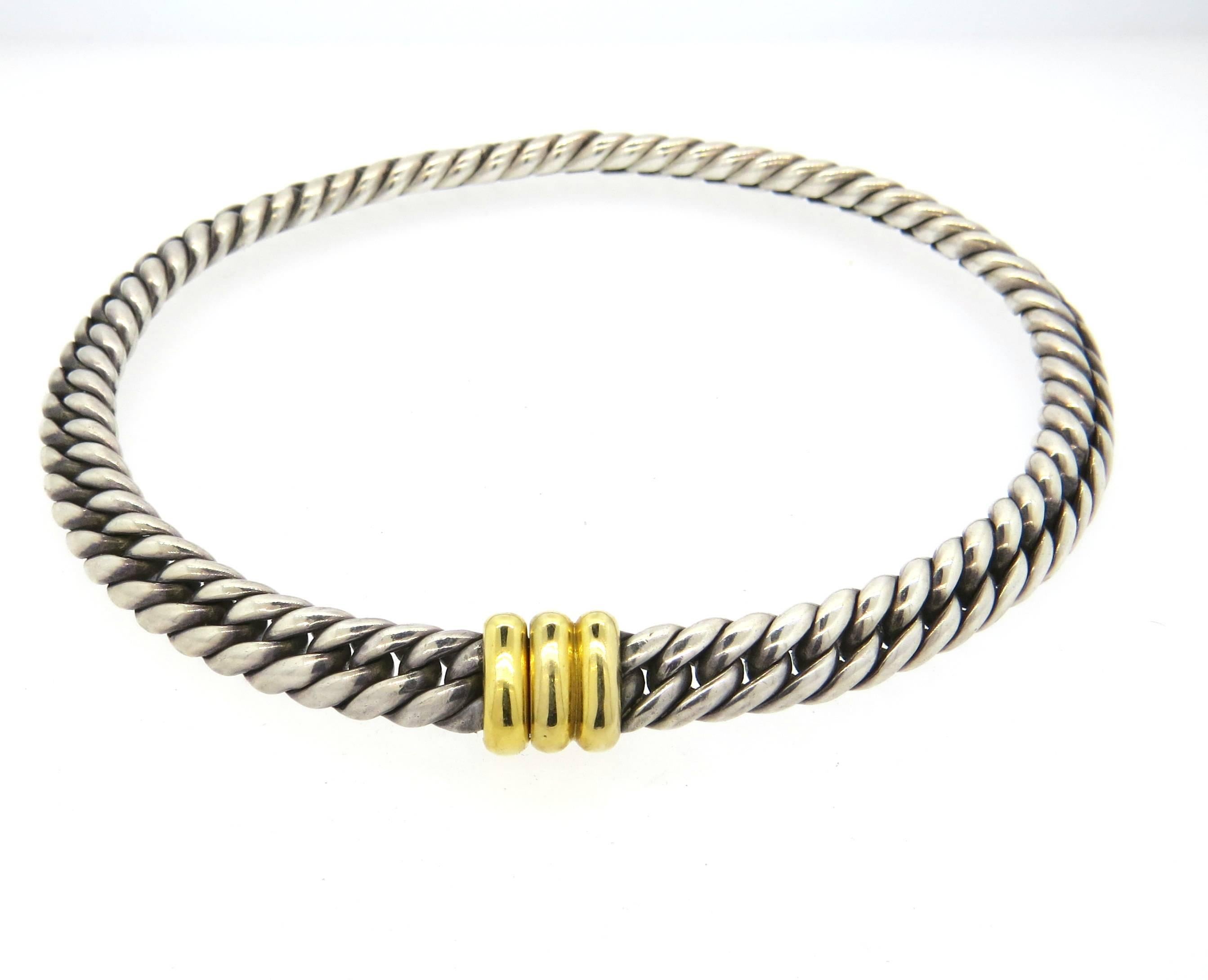 Heavy sterling silver and 18k yellow gold clasp necklace, crafted by Hermes. Necklace is 15 1/2