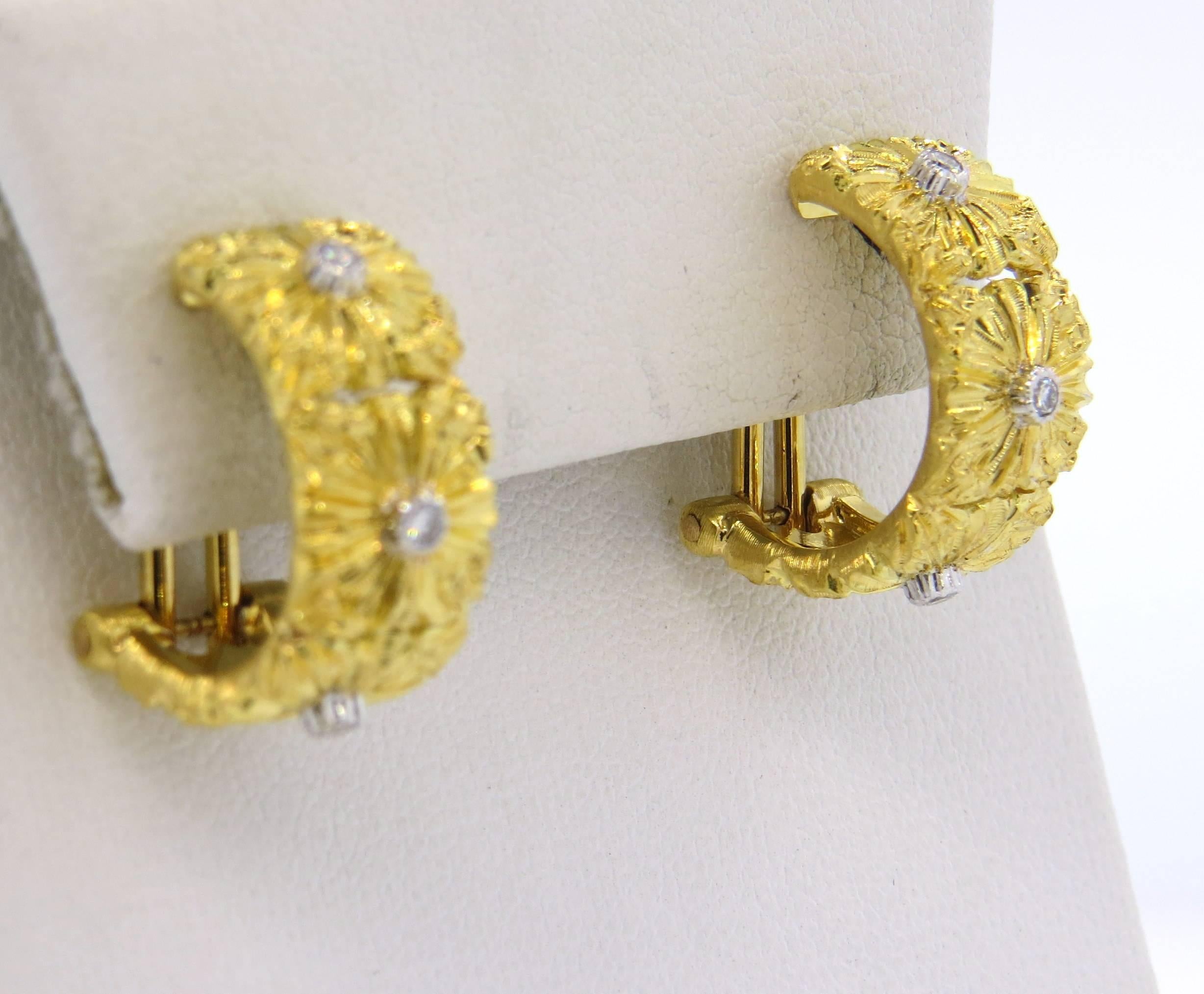 18k gold half hoop earrings, crafted by Buccellati, featuring flowers, each set with diamond in the center (total 0.16ctw) Earrings are 19mm long x 9mm wide. Marked: Buccellati, Italy, 18k. Weight - 12.9 grams
