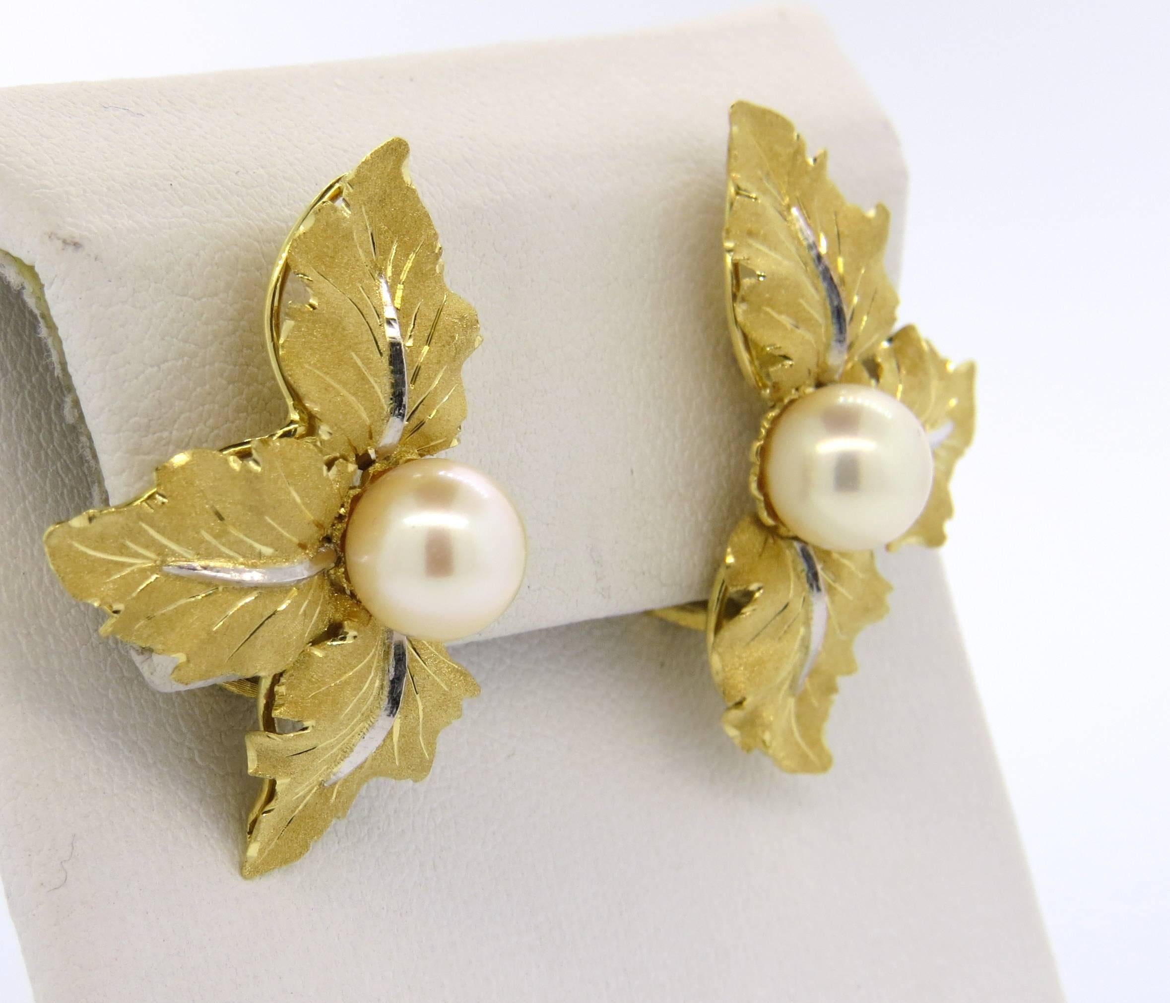 A pair of 18k yellow and white gold earrings, crafted by Buccellati, featuring 8mm pearls in the center, each surrounded by three leaves. Earrings measure 33mm x 23mm. Marked: Buccellati, Italy, 18k. Weight - 12.2 grams
Come with original