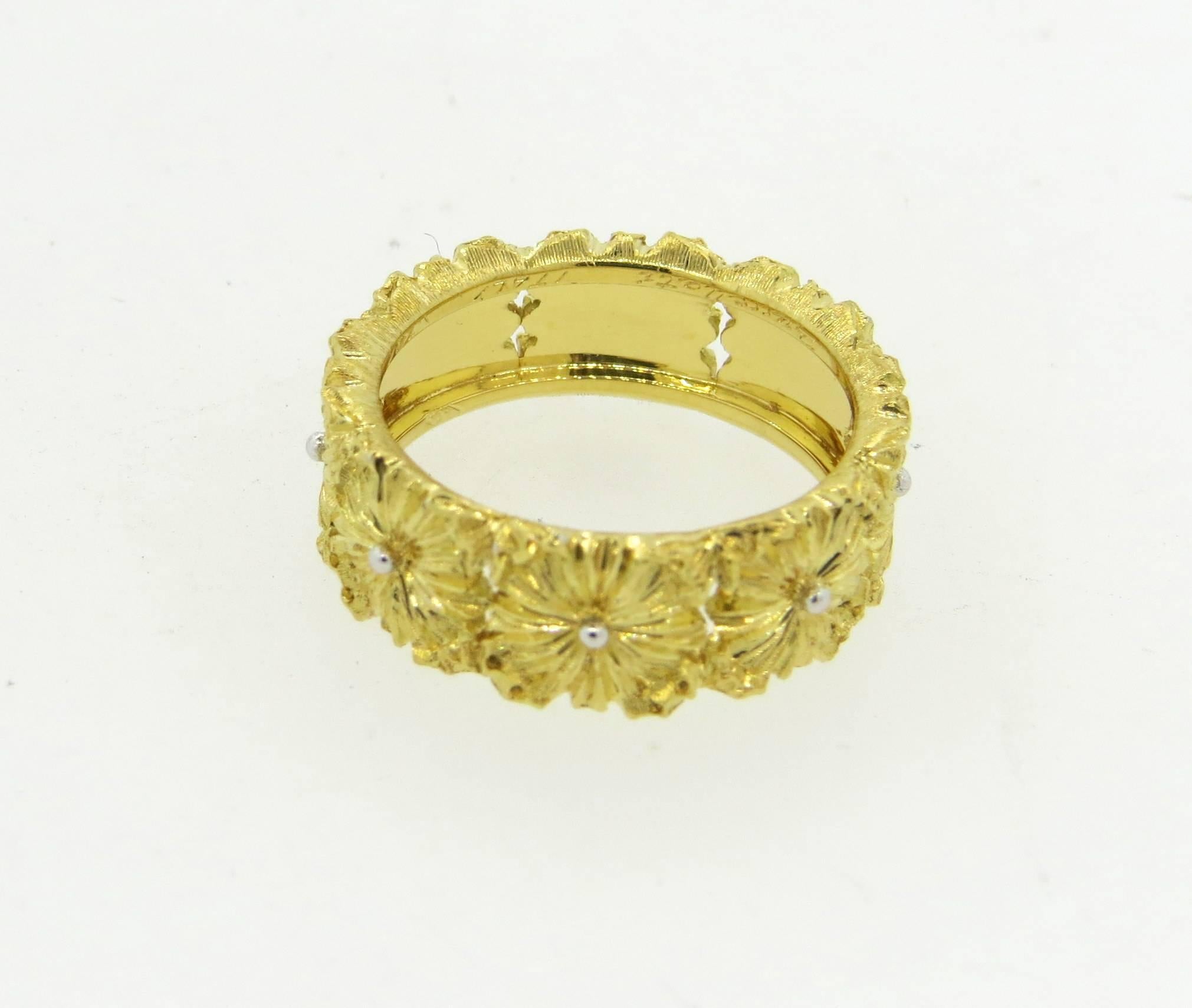 18k yellow and white gold flower band ring, crafted by Buccellati. Ring is a size 6, ring is 7.1mm wide. Marked: 18k, Buccellati. Weight of the piece - 6.3 grams
Comes with original Buccellati paperwork 