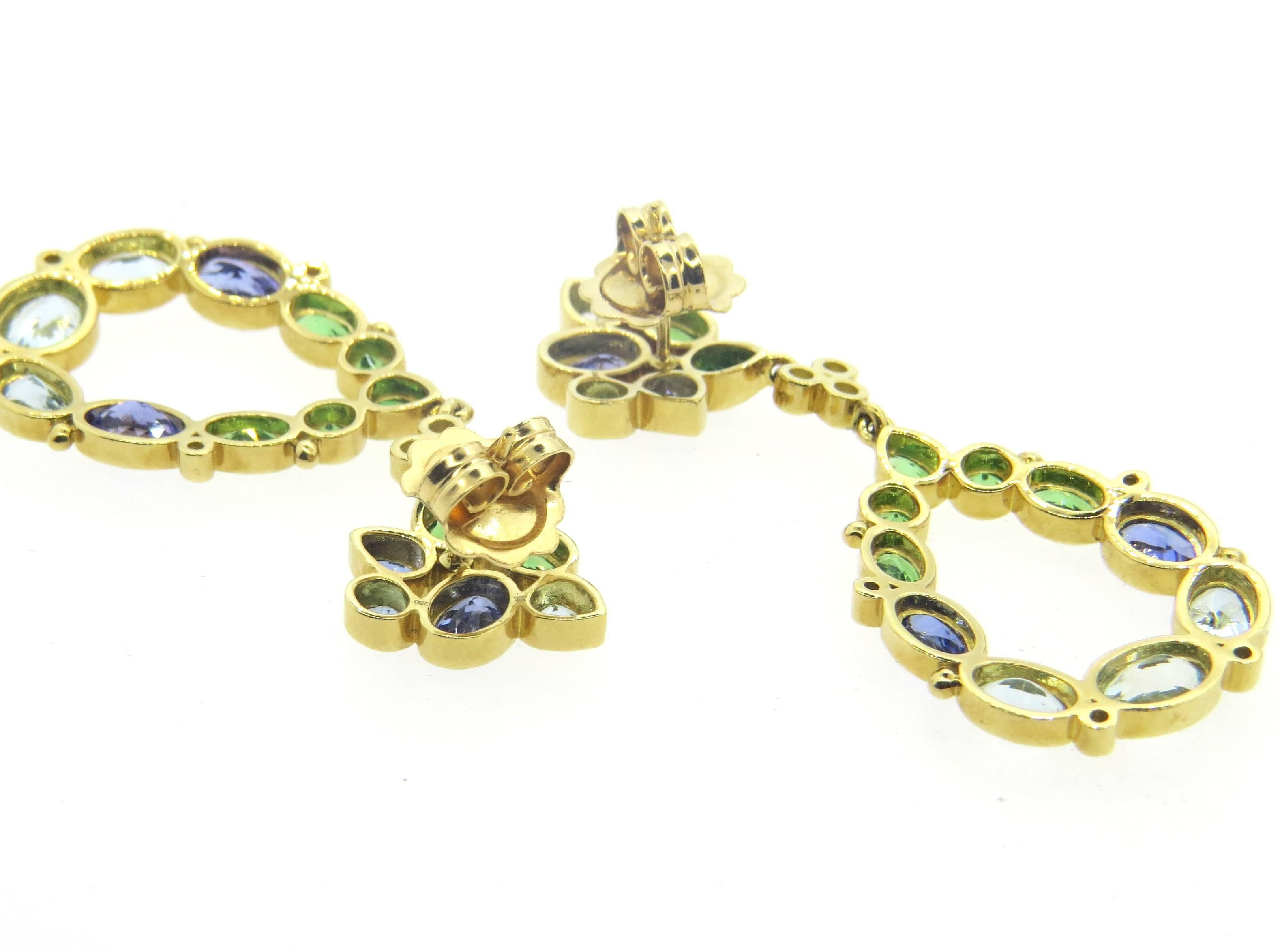 A pair of new 18k yellow gold drop earrings, crafted by Temple St. Clair for Anima collection, featuring 0.28ctw in diamonds, tsavorite garnets, tanzanites and aquamarine gemstones. Earrings are 52mm long x 21mm at widest points. Marked with 750 and