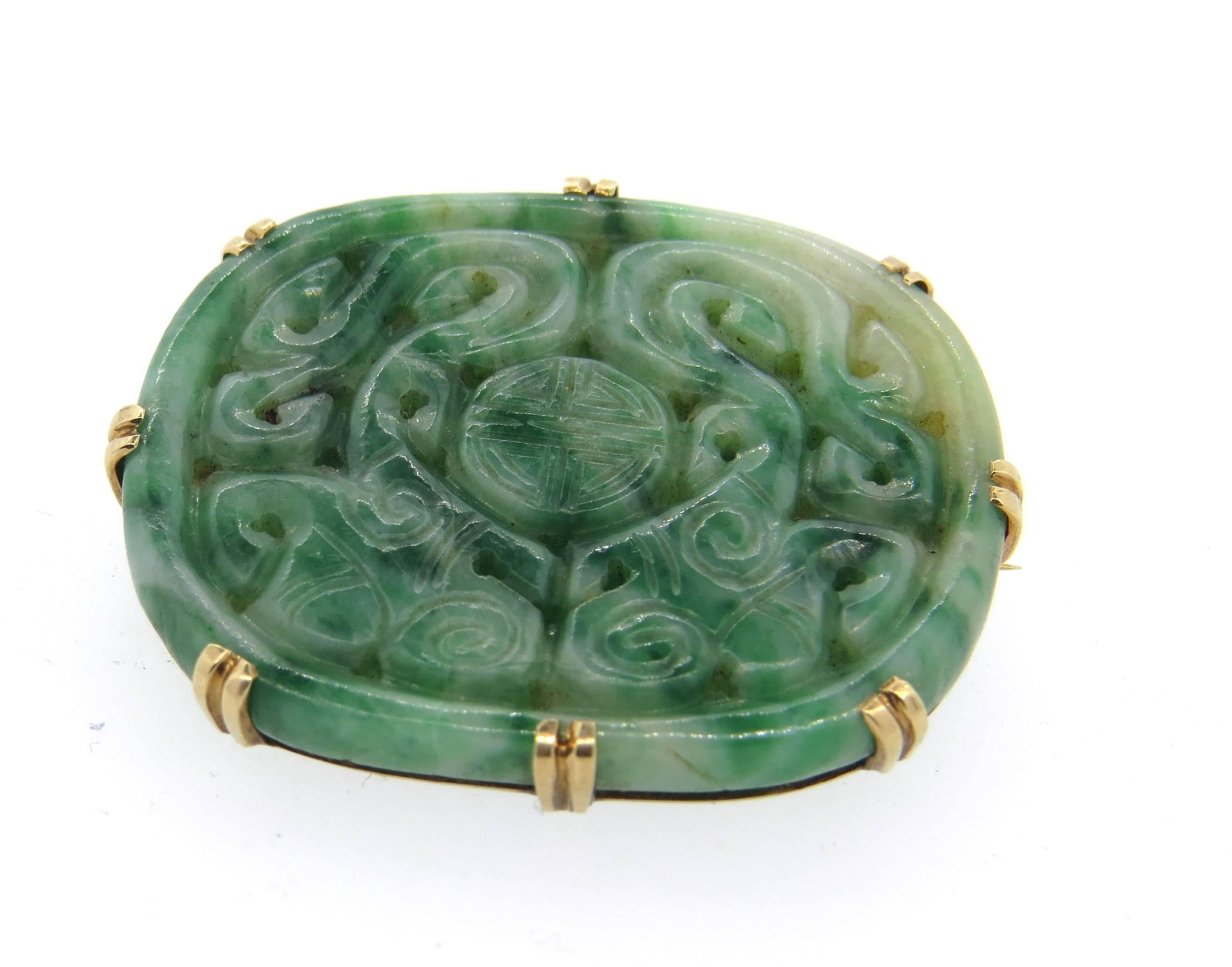 Antique 14k gold brooch, featuring carved jade top. Brooch measures 36mm x 29mm. Weight of the piece - 10 grams 