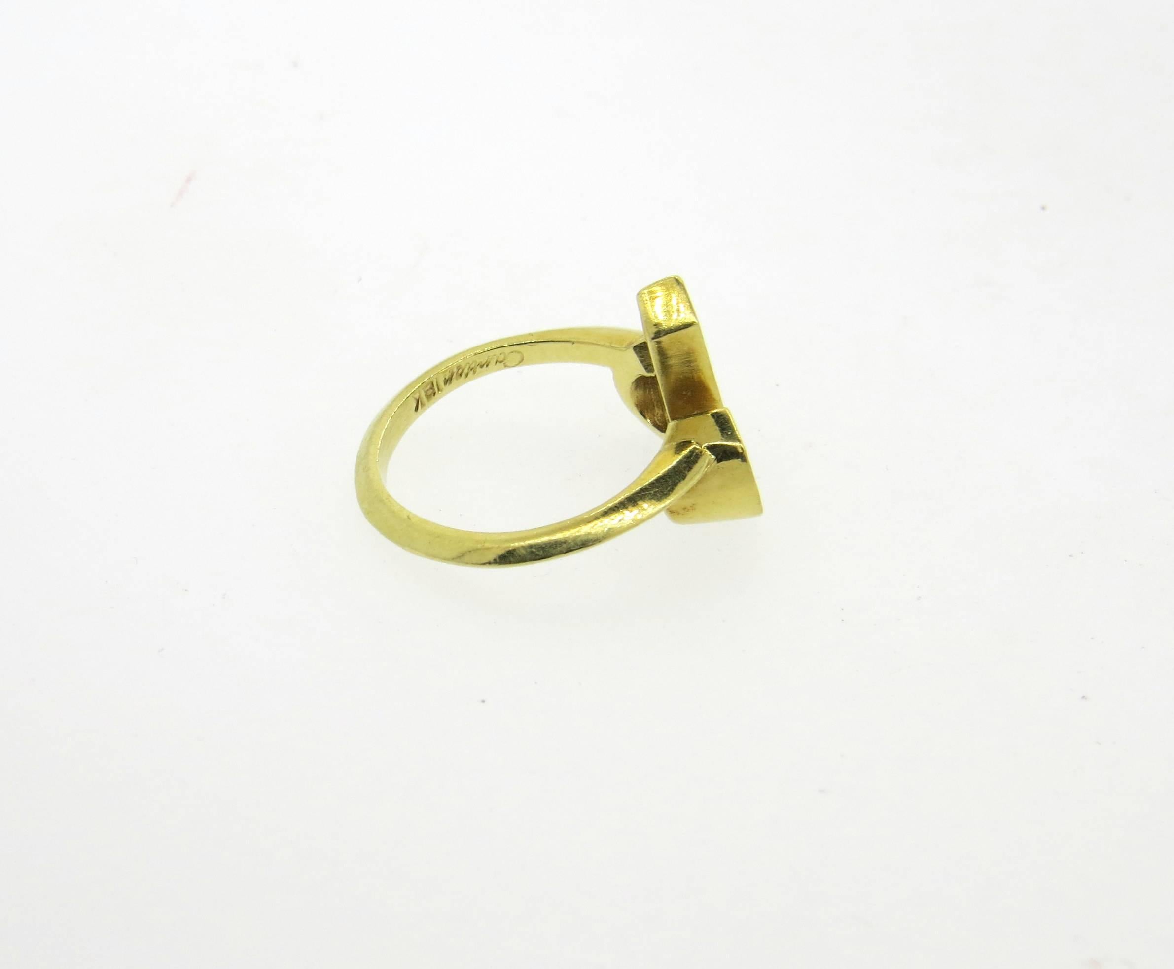 An 18k yellow gold ring, crafted by Cartier, featuring Aries zodiac sign. Ring is a size 6, ring top is 14mm x 15mm. Marked: Cartier, 38222, Cartier, 18k. Weight of the piece - 5.6 grams 
