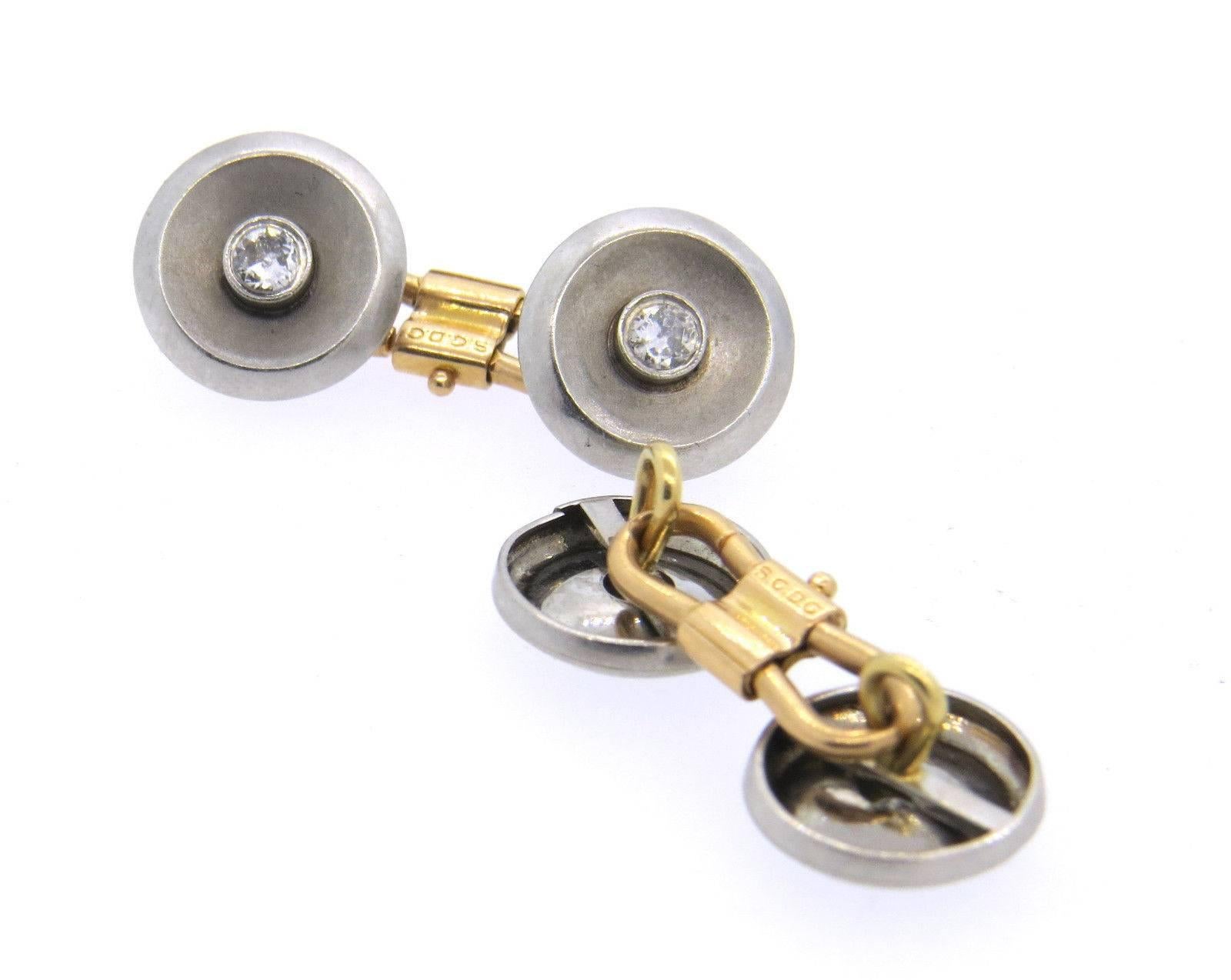 A pair of French Deco 18k yellow and white gold cufflinks set with approx. 0.60ctw of H/SI diamonds.  The cufflinks measure 12.5mm in diameter.  Marked: Brevete, SGDC.  The weight of the cufflinks is 9.1 grams.