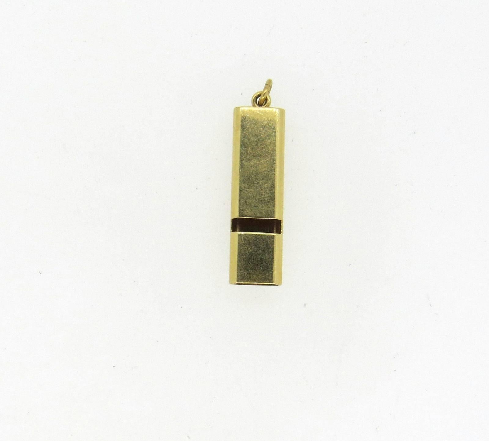 A 14k yellow gold working whistle charm by Tiffany & Co.  The charm measures 40mm x 10.5mm x 6.7mm and weighs 6.2 grams. Marked: Tiffany & Co 14k.