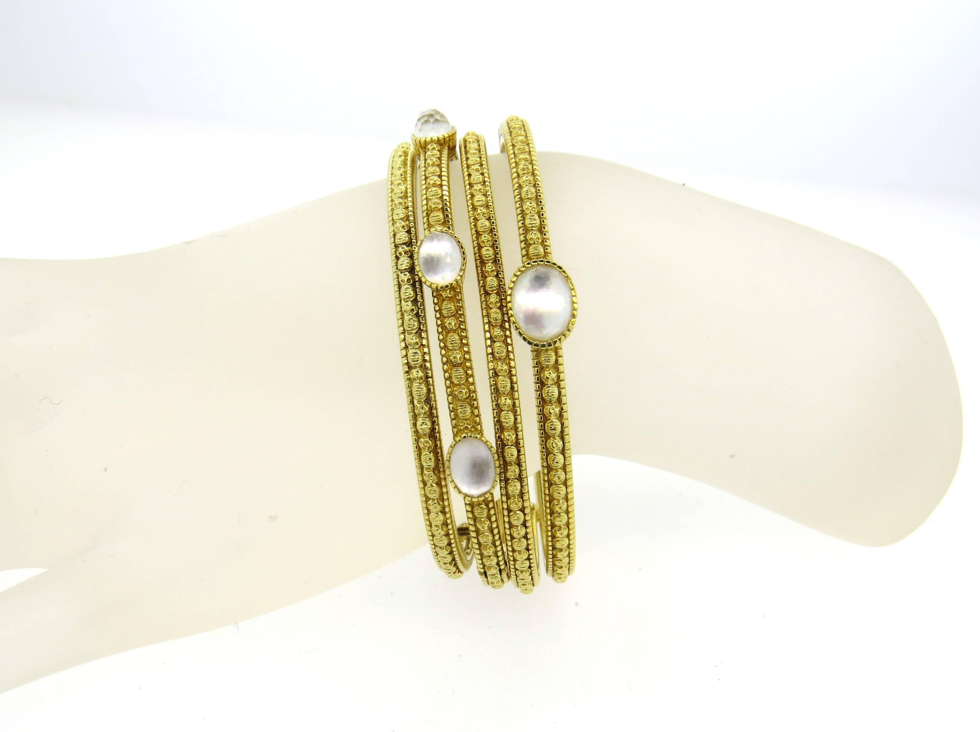 Set of four 18k yellow gold cuffs, crafted by Judith Ripka, decorated with faceted crystal backed with mother of pearl. Bracelets will all fit up to 6 3/4