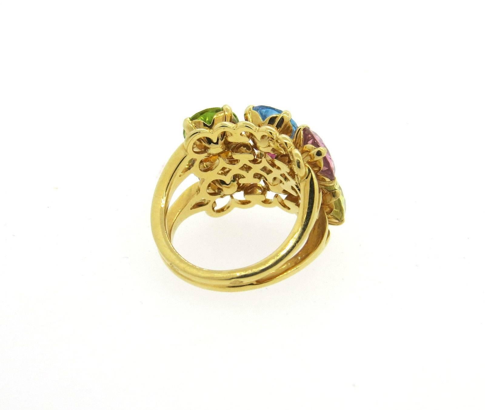 An 18k yellow gold ring set with topaz, peridot, citrine and tourmaline.  Crafted by Christian Dior, the ring is a size 6, ring top is 15mm x 19mm. Marked: 750, Dior, 08109-52.  The weight of the piece is 9.3 grams.