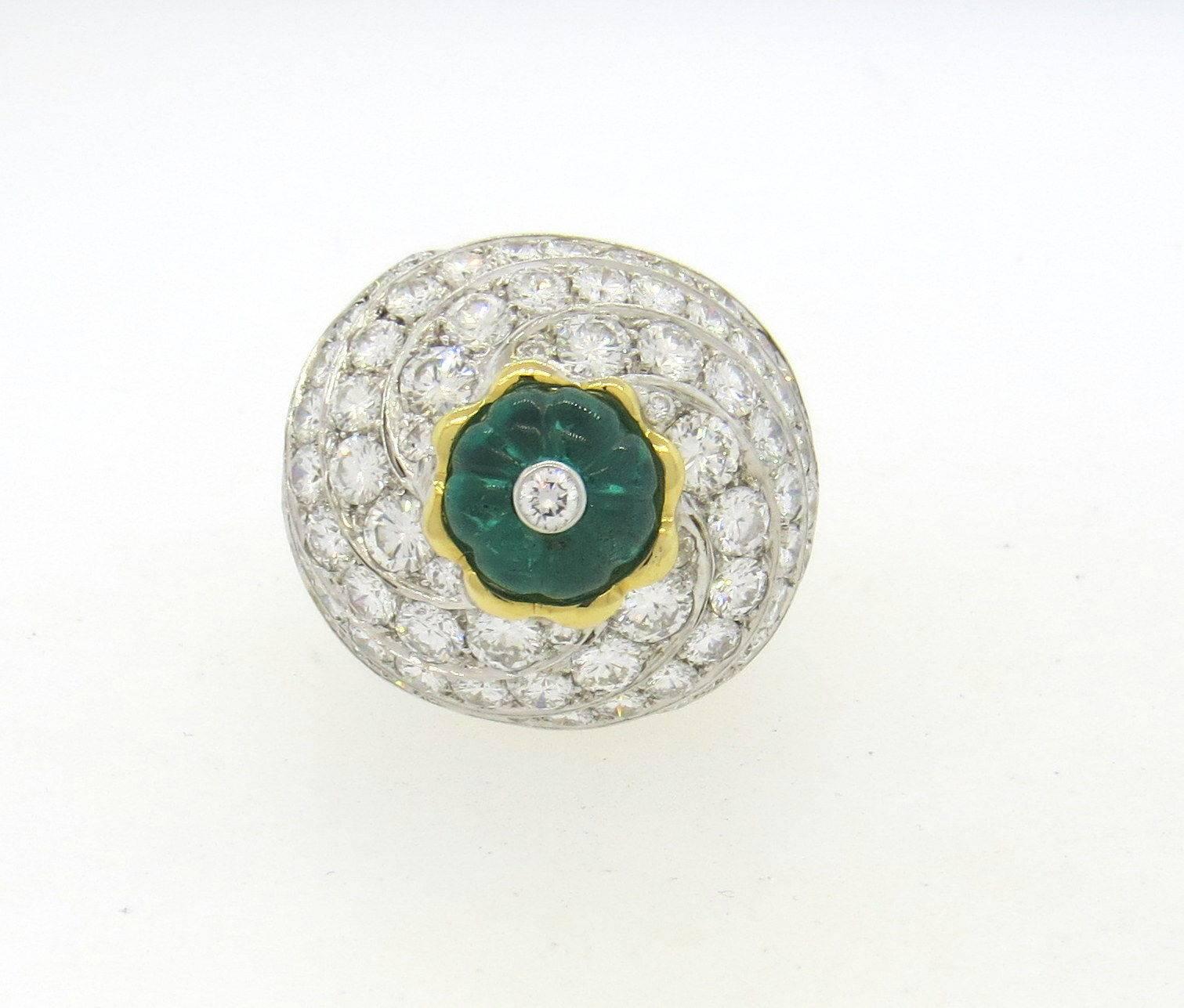 An 18k yellow gold and platinum ring set with a 3.76ct carved emerald and 8 carats of G/VS diamonds.  Crafted by David Webb, the ring is a size 6 1/2, ring top is 22mm x 24mm, sits approx. 20m from the finger.  Marked: David Webb 900pt, 18k, DS118. 