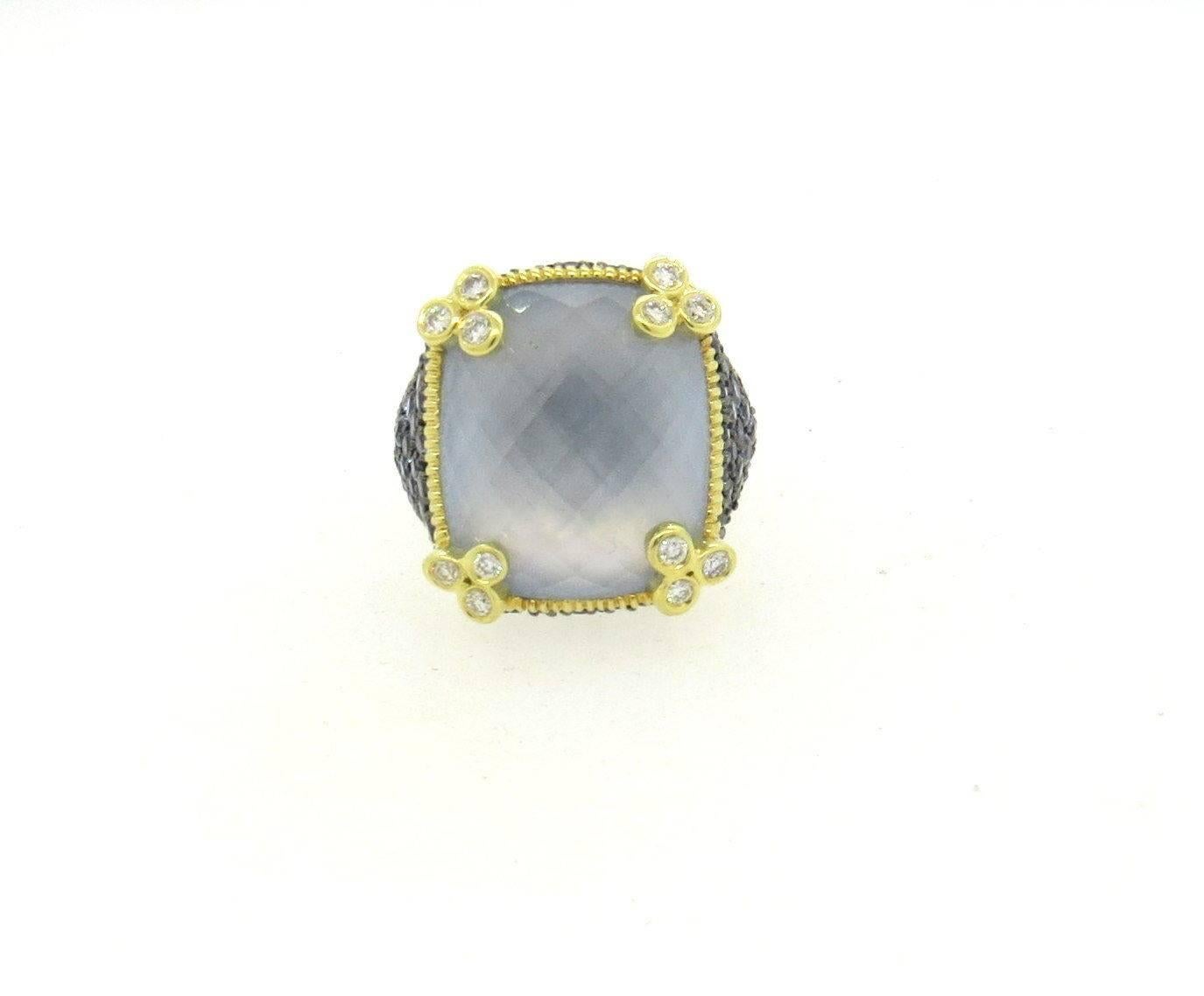 18k yellow gold ring set with blue gemstones, blue topaz - 17mm x 15mm, and approximately 0.64ctw of H/VS diamonds.  Crafted by Judith Ripka, the ring size 5 1/2 (sizing balls can be removed to increase size) top of the ring - 19mm x 17mm.  Marked: