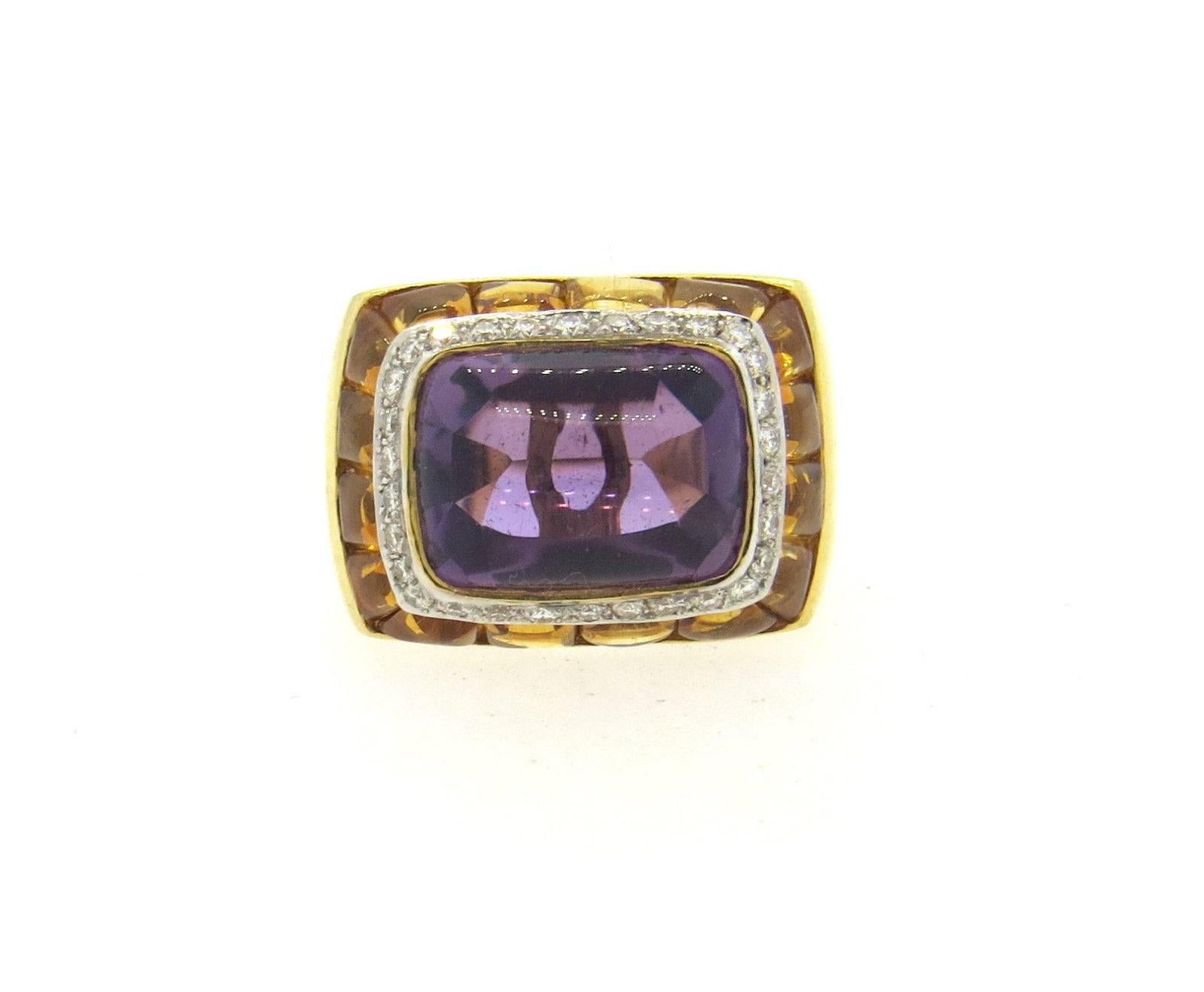 An 18k yellow gold cocktail ring set with amethyst, sugarloaf citrines, and approximately 0.30ctw of G/VS diamonds.  The ring is a size 6, ring top measures 15mm x 21mm.  The weight of the ring was 15.6 grams.