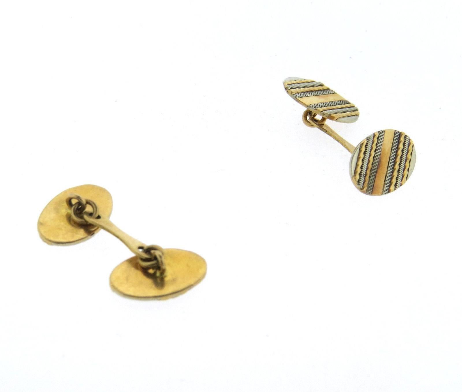 A pair of 18k yellow and white gold cufflinks measuring 17mm x 11mm and weighing 9.8 grams.