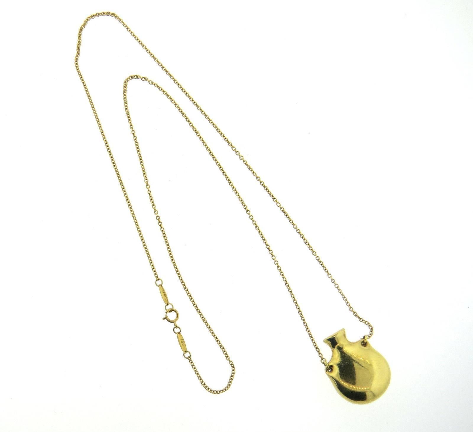 An 18k yellow gold perfume bottle pendant necklace.  Crafted by Elsa Peretti for Tiffany & Co, the necklace is 25