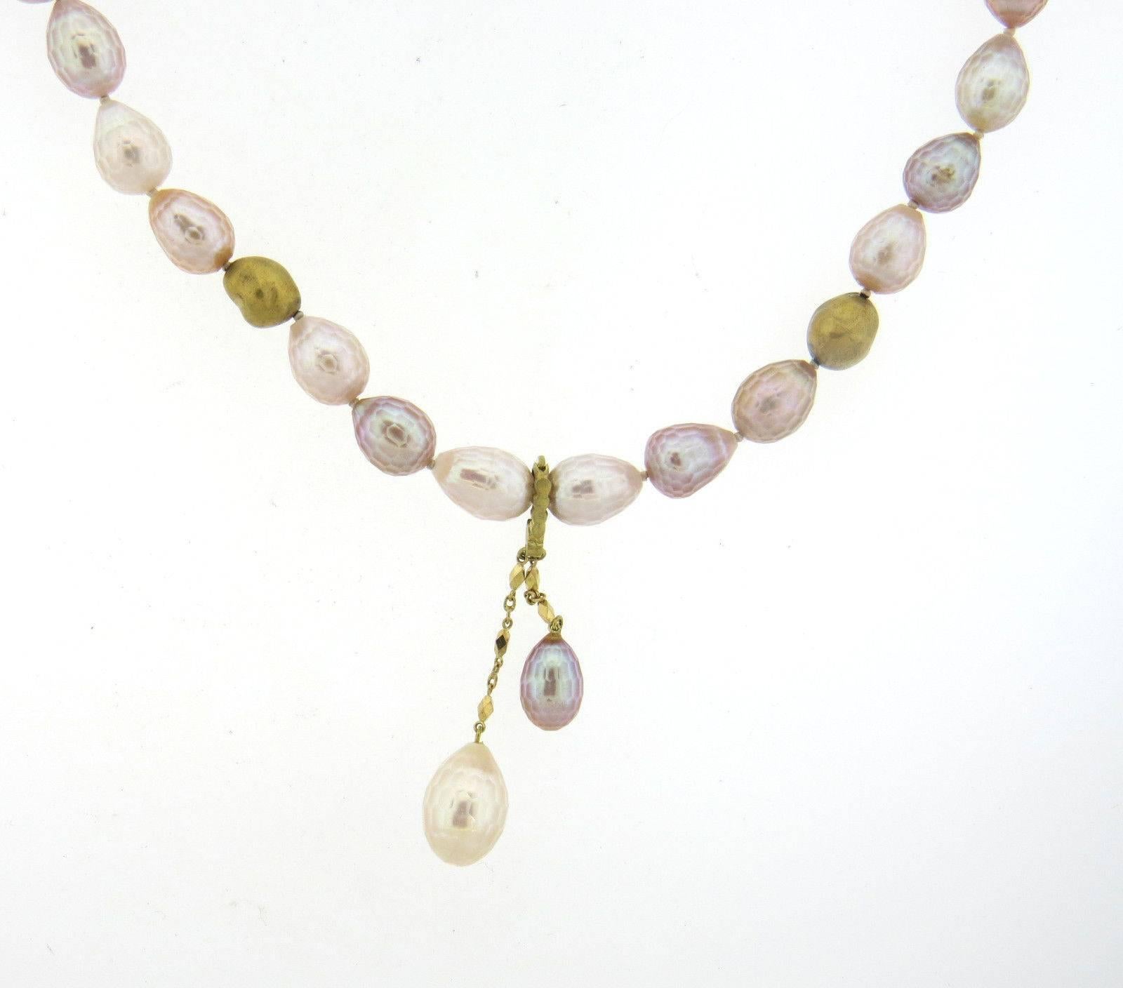 An 18k yellow gold necklace set with faceted pearls - approx. 7.5mm x 12mm to 10mm x 15.5mm.  Crafted by Robin Rotenier, the necklace measures 15 3/4