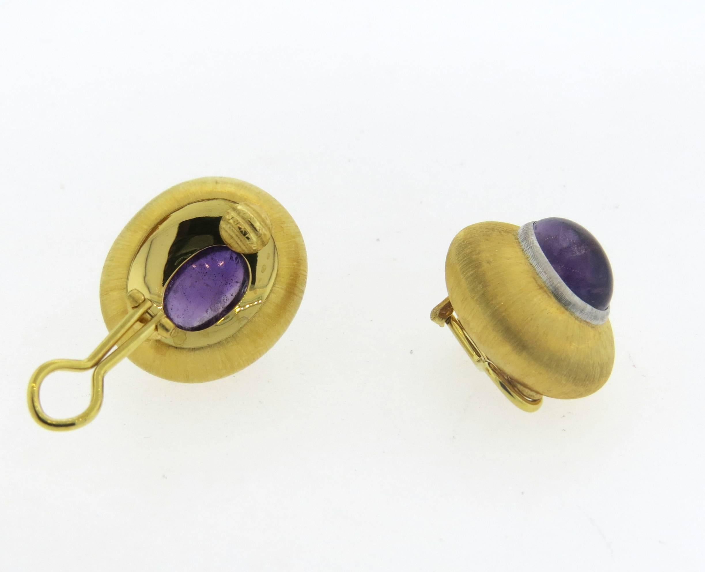 A pair of 18k yellow and white gold large earrings, crafted by Buccellati, set with two amethyst cabochons, weighing 11.28ctw total. Earrings are 24mm x 21mm. Marked: Buccellati Italy 18k. Weight - 19.6 grams
