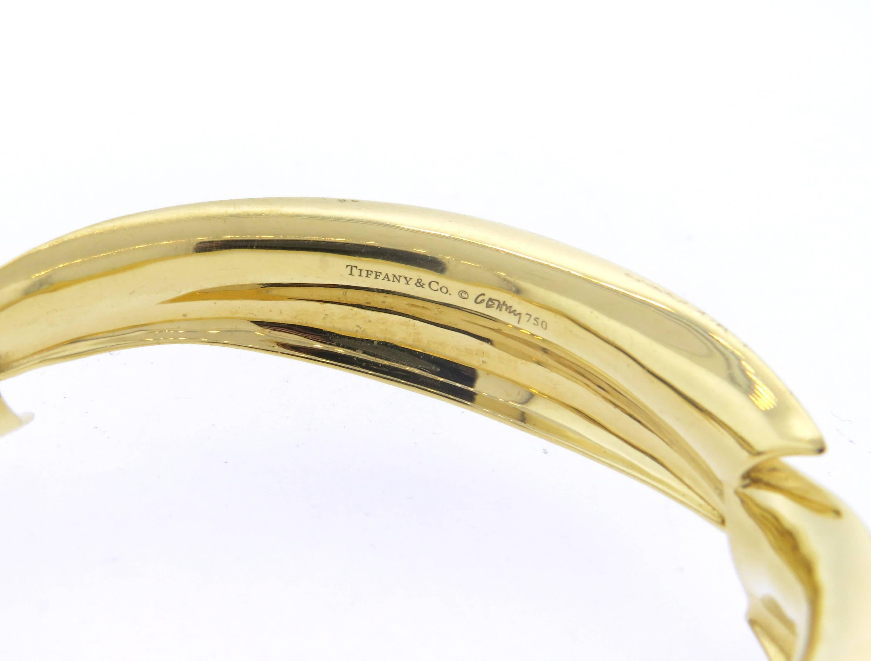AN 18k yellow gold bangle bracelet, crafted by Frank Gehry for Tiffany & Co, featuring signature Fish motif design. Bangle will fit up to 7 1/4' wrist and is 16mm wide. Marked: Tiffany & Co,  Gehry 750. Weight of the piece - 53.2 grams 