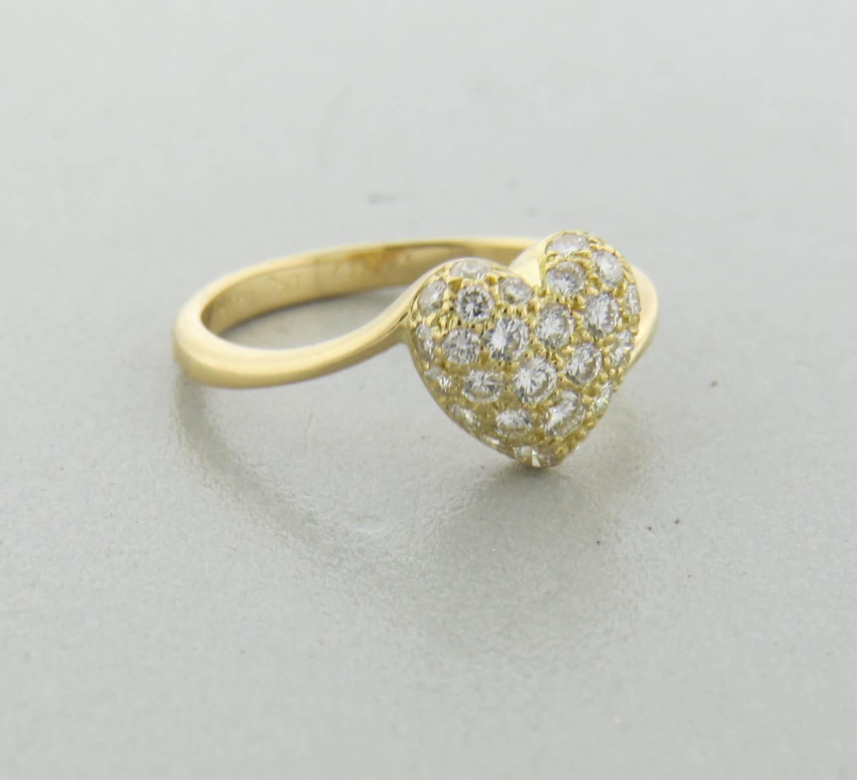 Delicate 18k yellow gold ring, crafted by Cartier, featuring heart top, set with approx. 0.68ctw in G/Vs diamonds. Ring size 7, ring top is 9.2mm x 9.8mm. Marked: Cartier, 750, E37325, 54, French mark. Weight of the piece - 3.1 grams