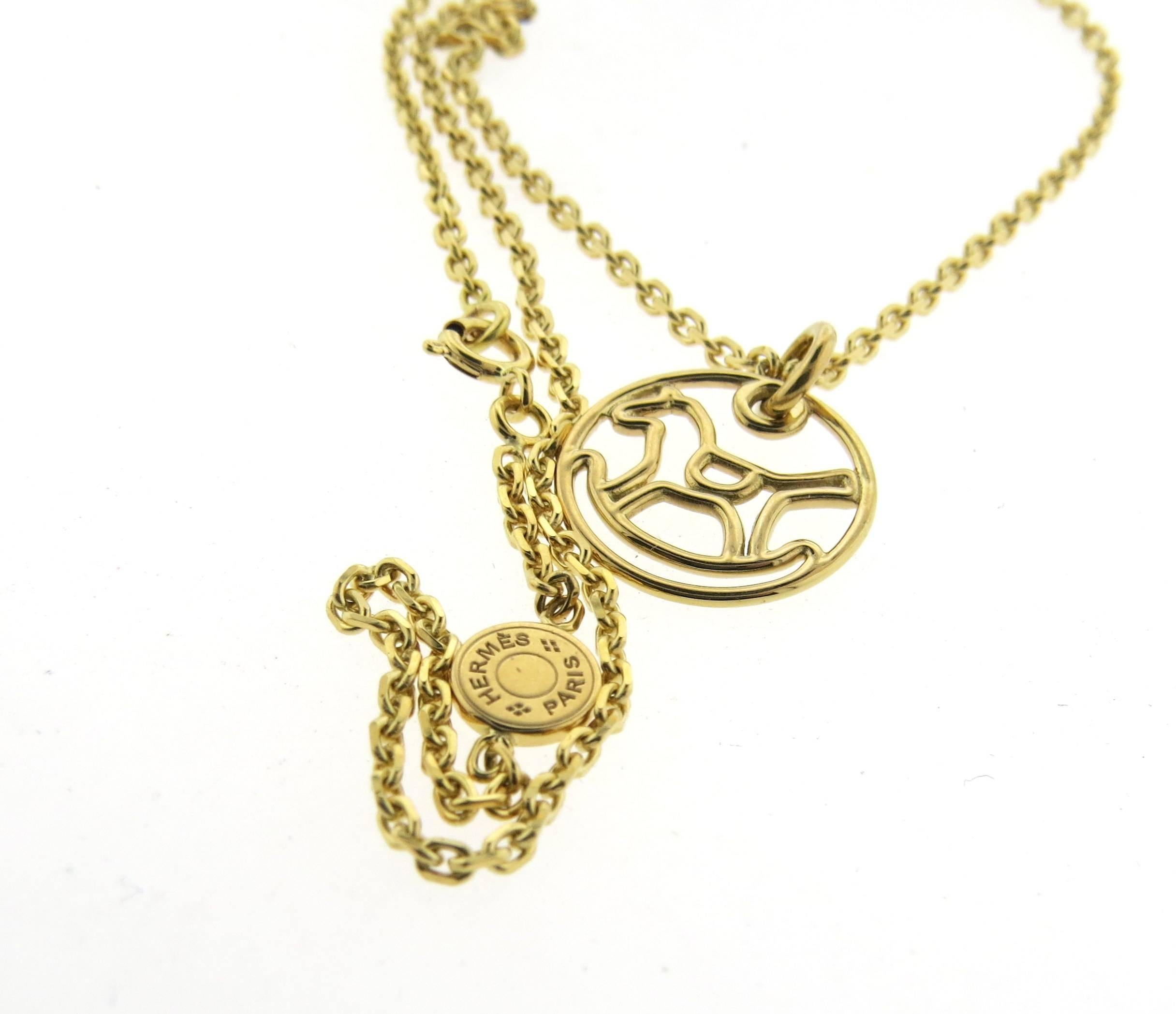 18k yellow gold necklace, featuring cute rocking horse circle pendant, crafted by Hermes. Necklace is 15 3/4" long, pendant is 17mm in diameter . Marked: Hermes, Paris, 750, 063291, au750, 0516747. Weight - 8.9 grams 