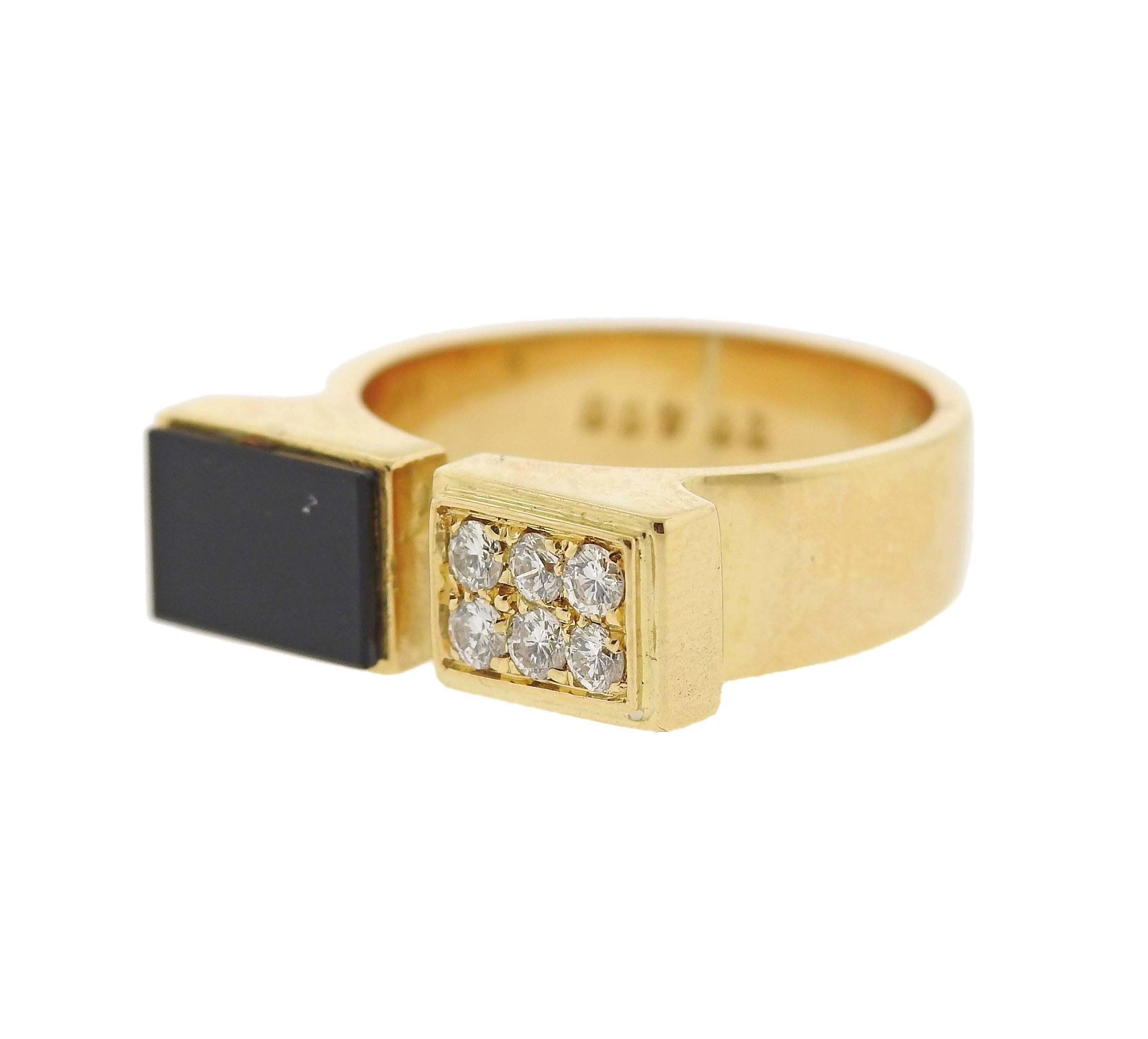 An 18k yellow gold open cuff ring by Cartier, decorated with onyx and approximately 0.18ctw in diamonds. Ring is a size 5, ring top is 6mm x 18mm.  Marked: Cartier, 750, 49, 28468. Weight of the piece - 6.3 grams.