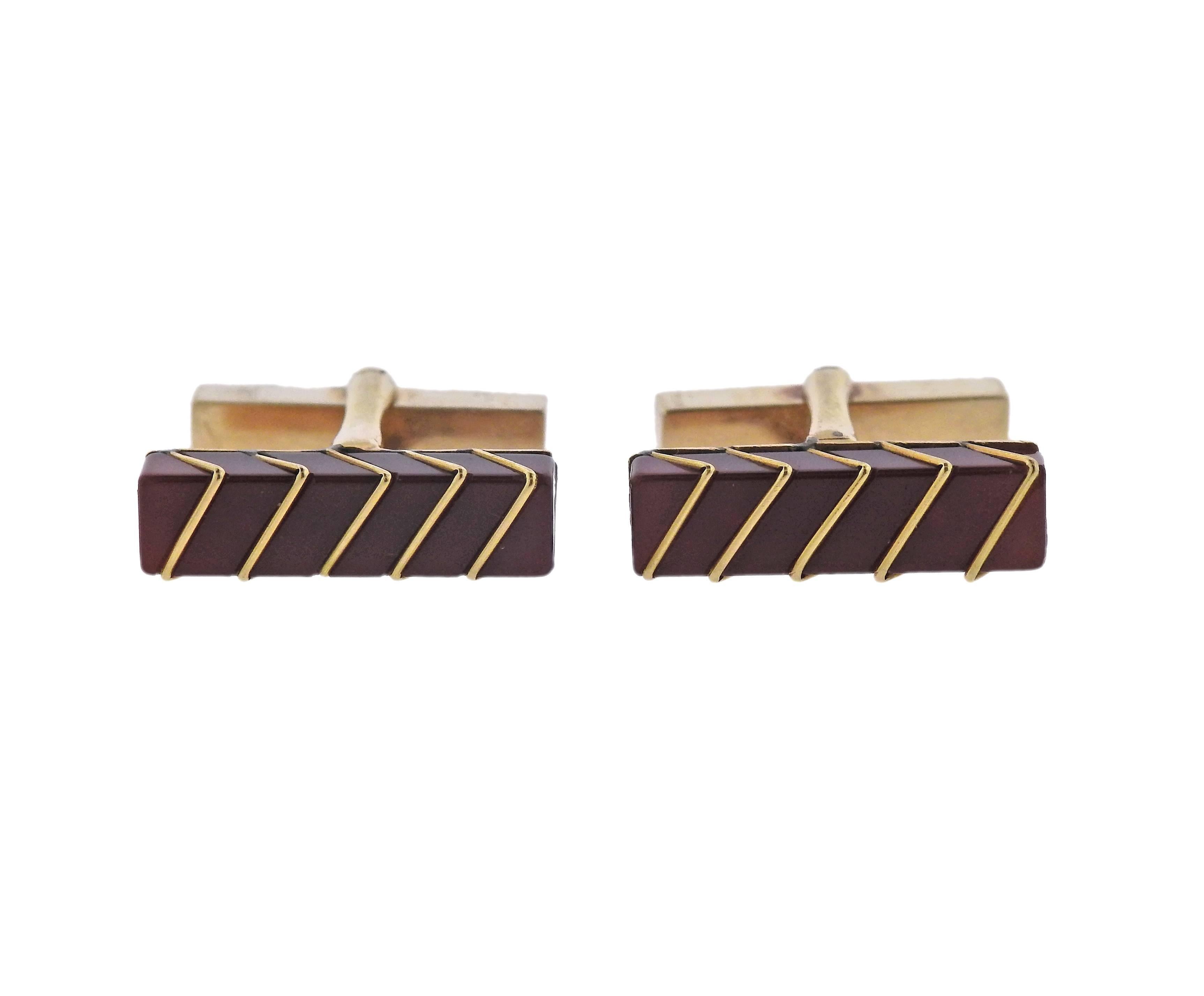 Pair of 18k yellow gold bar cufflinks, crafted by Tiffany & Co, set with carnelian. Top measures 11mm x 6mm. Marked: Tiffany & Co, 18k. Weight - 11.3 grams. 