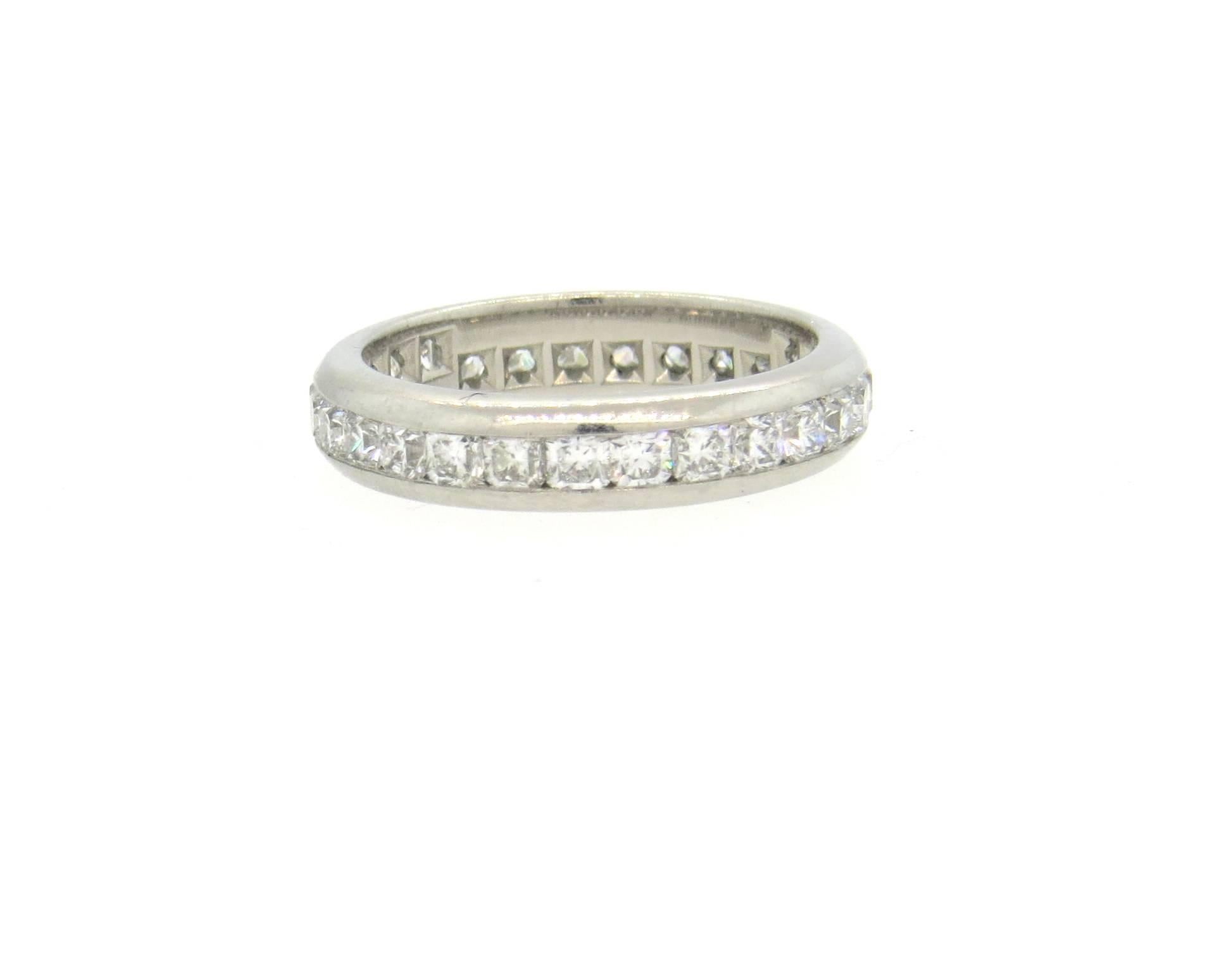 Gorgeous and classic platinum 4mm wedding band ring, crafted by Tiffany & Co for Lucida collection, set with a full circle of G/VS diamonds - a total of approximately 1.10ctw. Ring is a size 4 3/4. Marked T & Co, pt950, Lucida, pat. 597044 et al.