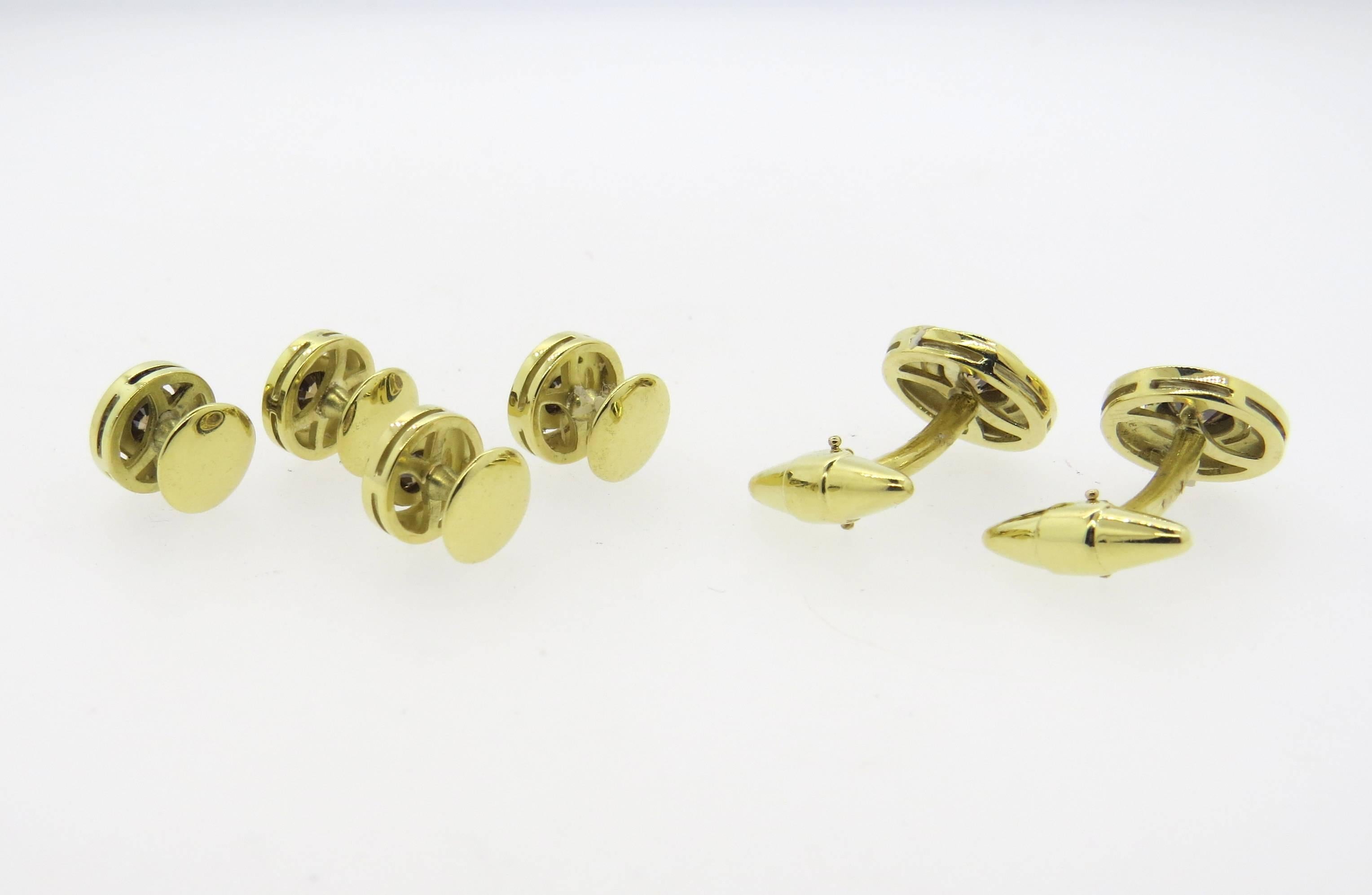 Classic 18k yellow gold dress set, featuring pair of cufflinks and four shirt studs. Cufflink top measures 15mm in diameter, stud top - 10mm in diameter. Decorated with a total of 4.00ctw in fancy color diamonds. Weight of the set - 27.7 grams.