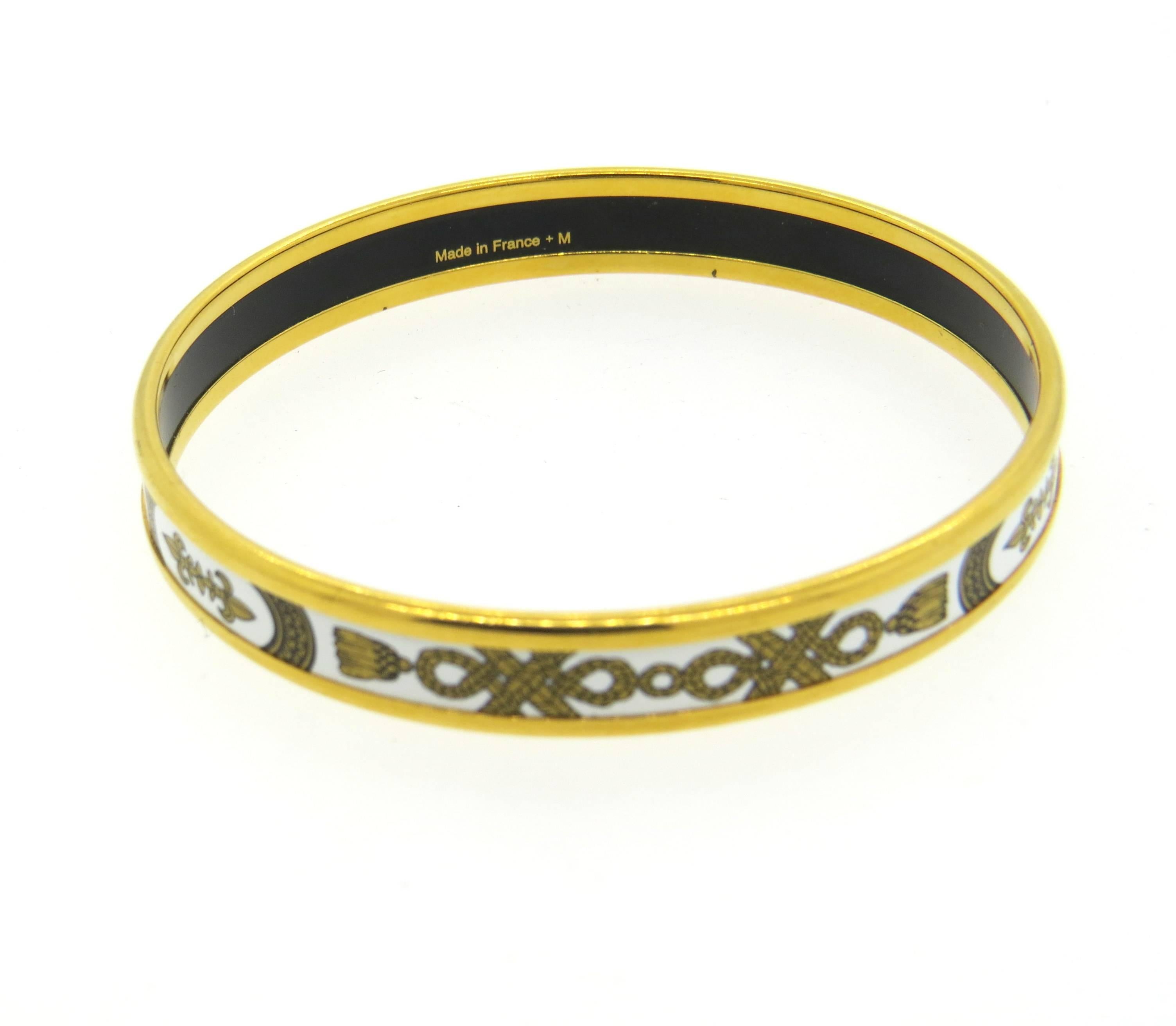 Hermes bangle bracelet, decorated with Fleur de Lis enamel ornament. Bracelet's inner diameter is 62mm (will fit approx. 6 1/2