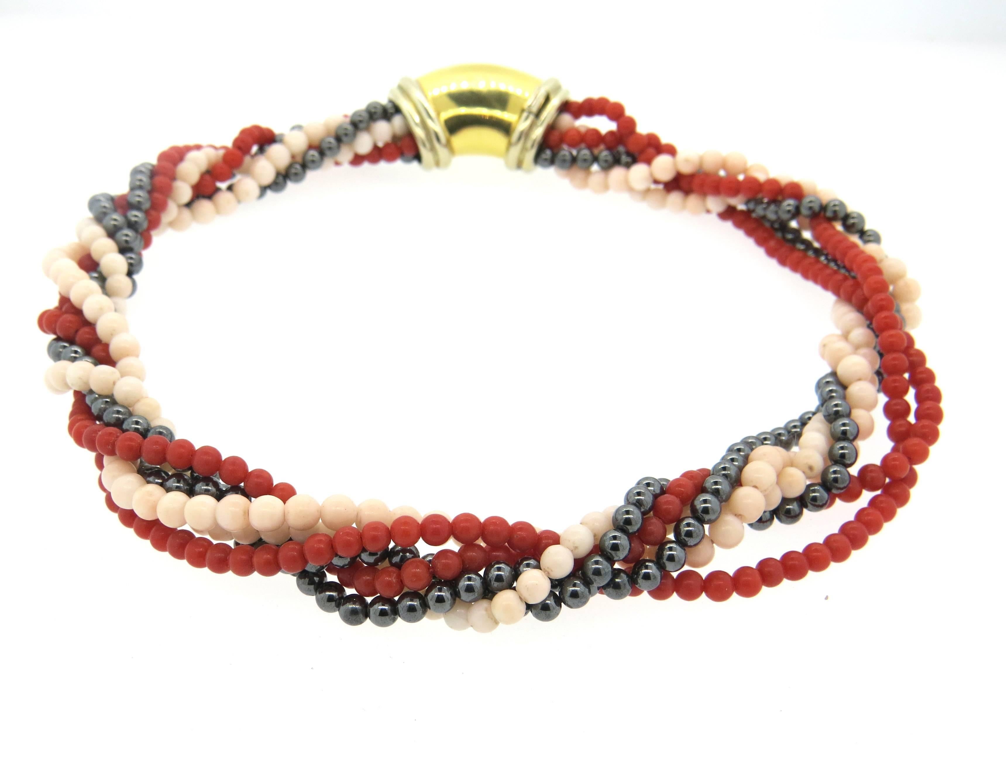 Chaumet necklace, set with multi strands of red, angel skin coral and hematite beads - measuring approximately 4mm - 5mm. Necklace is decorated with 18k yellow gold clasp - measuring 33mm x 18mm. Necklace is 16