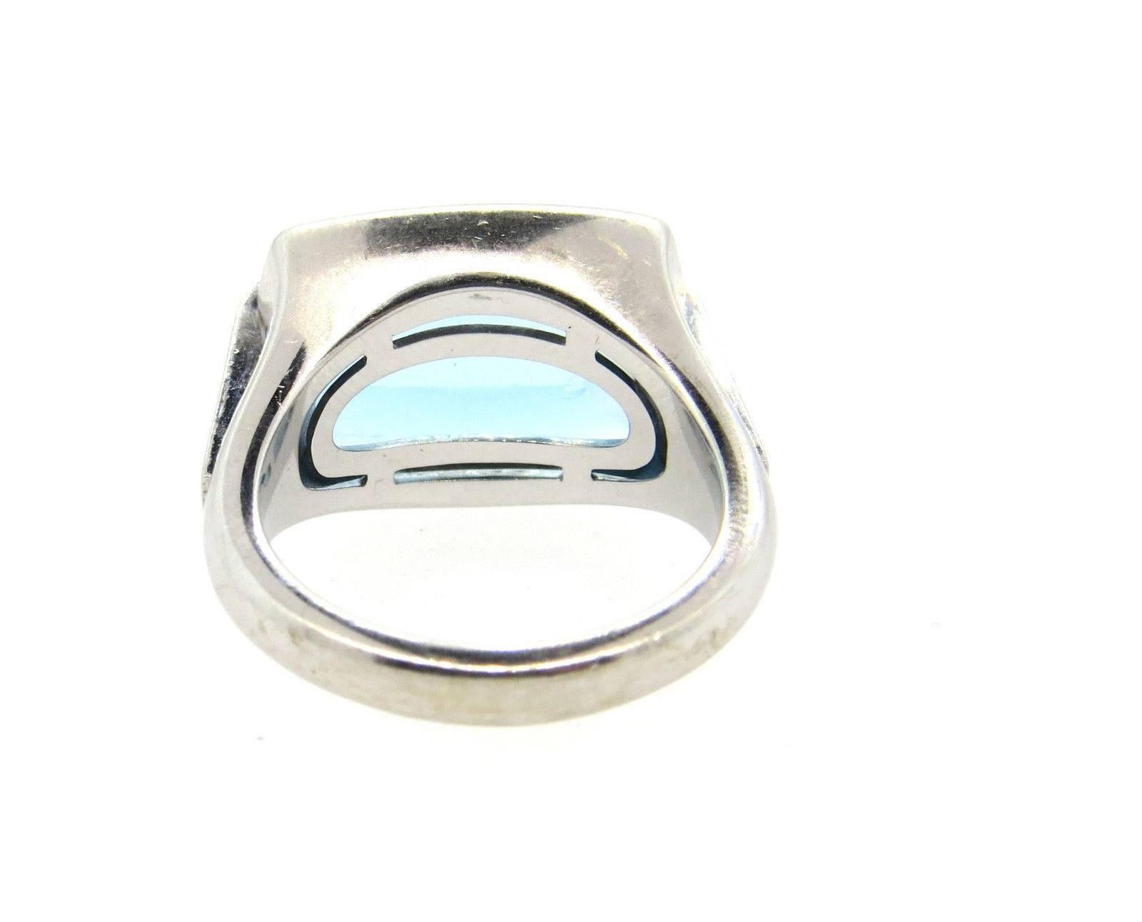 18k white gold ring, crafted by Bulgari, set with blue topaz as a centerpiece. Ring size 7.5, top measures 19.5mm x 14.1mm. Marked Blvgari and 750. Weight of the piece - 13.8 grams