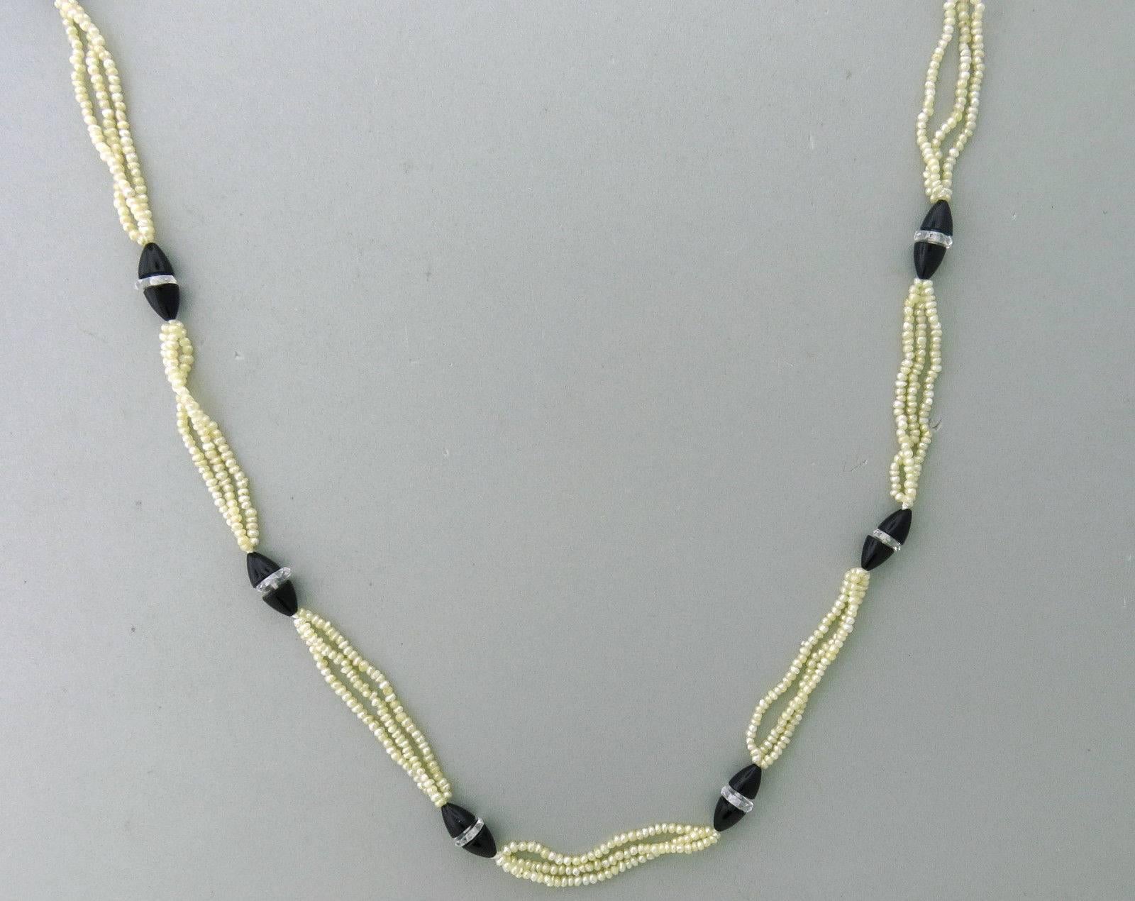 Vintage 1920's Mikimoto 18K white gold necklace featuring pearls, onyx and cut crystals. The necklace is 43