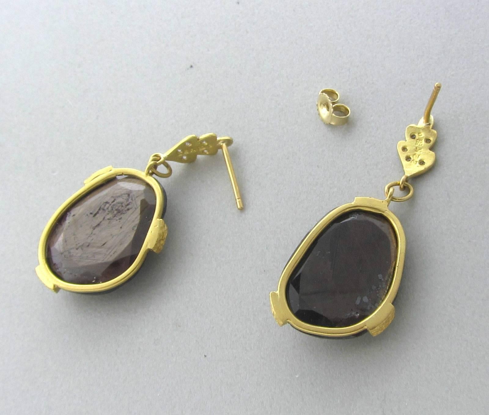 Cathy Waterman drop earrings featuring brown sapphires and decorated with diamonds set in 22K gold. The earrings measure 38mm x 16mm and weigh 9.7g.  One earring is missing a back.